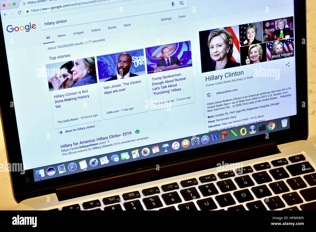 An Apple Macbook Pro displaying a Google search of Hillary Clinton Stock Photo