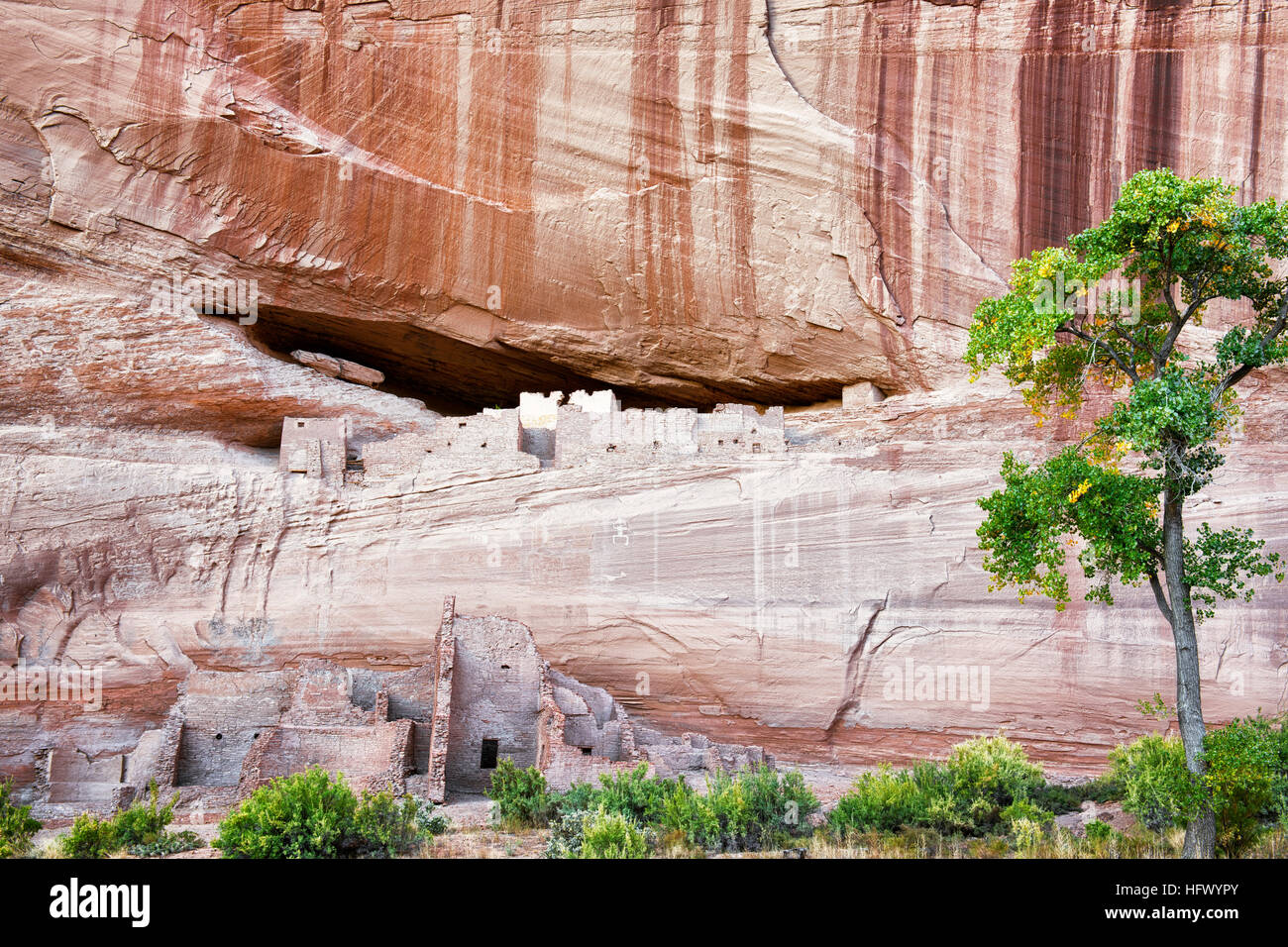Stripes of desert varnish above the Anasazi cliff dwellings known as White House Ruins in Arizona's Canyon de Chelly National Monument. Stock Photo