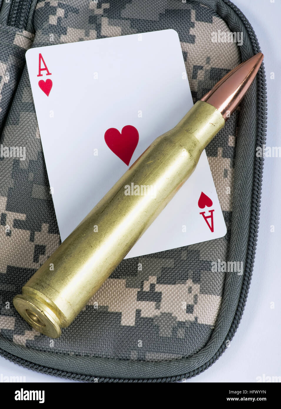 Ace of hearts and fifty caliber bullet. Stock Photo