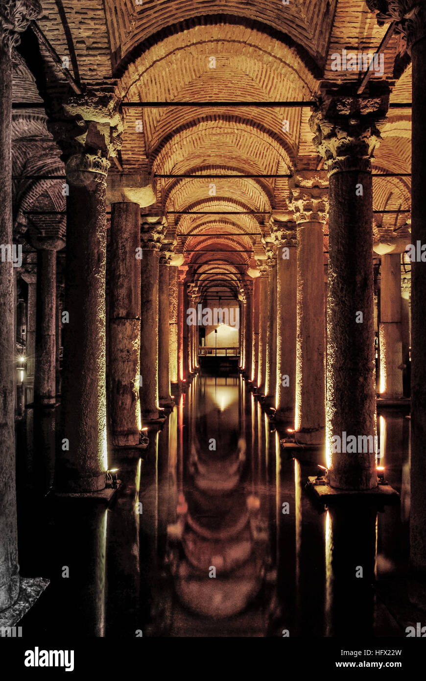 The Basilica Cistern, located in the crowded Eminonu district of Istanbul next to the Hagia Sophia, was built to provide water for the city of Istanbul during the reign of Emperor Justinian I in the 6th century CE. This cistern is an underground chamber of 138 x 64.6 metres. The large space is broken up by a forest of 336 marble columns, which are aesthetically supported by strong  columns and arches. The ceiling vaults, known as Manastir Tonozu (cloister vault), are built without using a mould. The cistern is surrounded by a firebrick wall with a thickness of 3.5 meters and is coated with a s Stock Photo