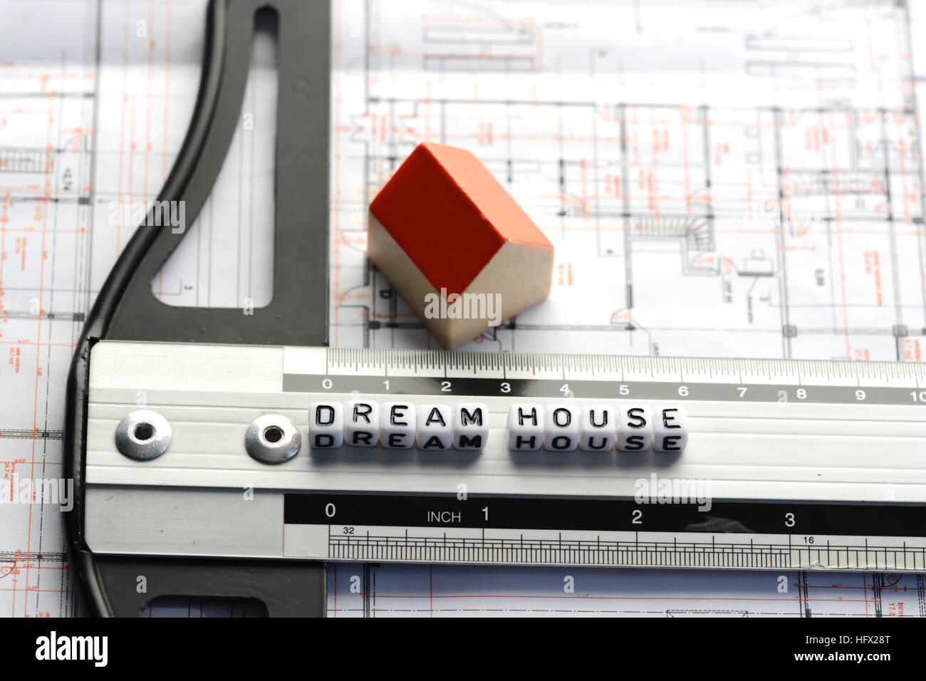 New house project with dream house text on ruler. Architecture plan and small model house on background Stock Photo