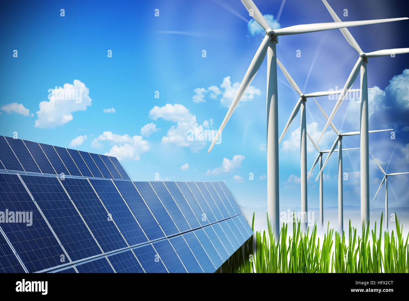 Renewable energy concept with solar panels and wind turbines on green field Stock Photo