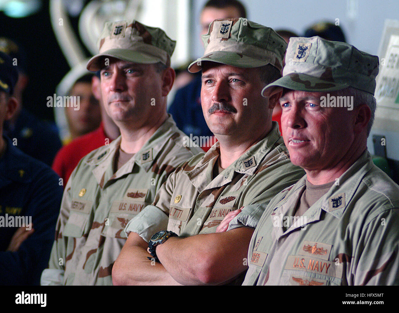 050712-N-0962S-136  Persian Gulf (July 12, 2005) - Three of the Navy's top Command Master Chiefs (CMCs) observe an all hands call by Master Chief Petty Officer of the Navy (MCPON) Terry Scott. From left, 3rd Fleet CMC Terry Etherton; 2nd Fleet CMC Don Kultti and 5th Fleet CMC Kelly Schneider, traveled throughout the Persian Gulf focusing on Sailors issues in regards to training, equipment, and manning. U.S. Navy photo by Journalist 1st Class Brandan W. Schulze (RELEASED) US Navy 050712-N-0962S-136 Three of the Navy's top Command Master Chiefs (CMCs) observe an all hands call by Master Chief Pe Stock Photo
