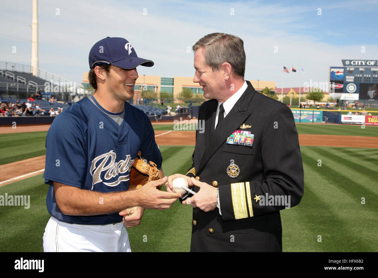 090306-N-3271W-040 PHOENIX, Ariz. (March 6, 2009) San Diego Padres pitcher Mitch Canham signs a baseball for Rear Adm. Leendert R. Hering Sr., commander of Navy Region Southwest after Hering threw the first pitch at a pre-season game at Peoria Sports Complex. Hering was on hand for festivities during Phoenix Navy Week, one of 22 Navy Weeks planned across America in 2009. Navy Week is designed to show Americans the investment they have made in their Navy and increase awareness in cities that do not have a significant Navy presence. (U.S. Navy photo by Senior Chief Mass Communication Specialist  Stock Photo