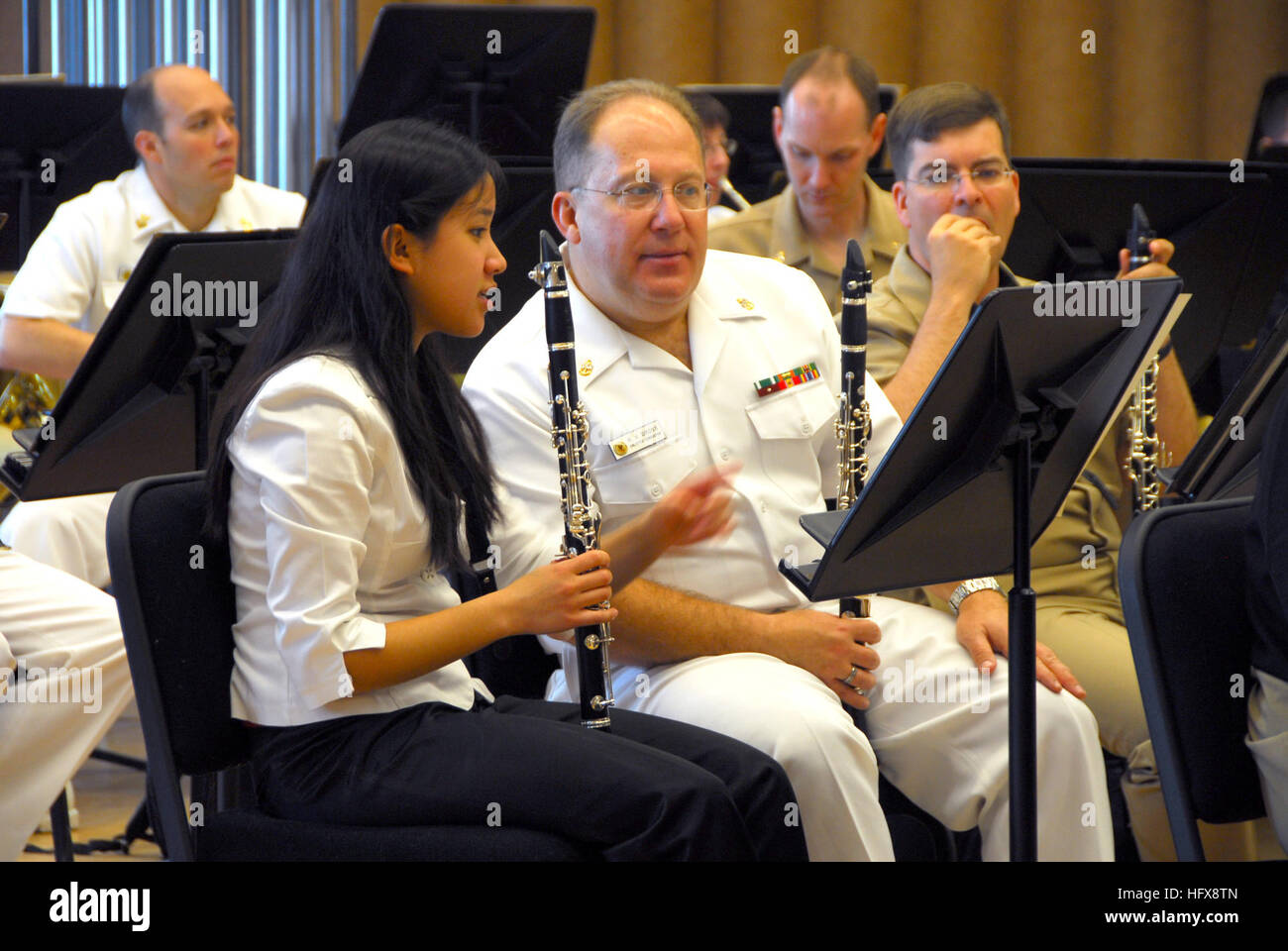 090506-N-0773H-023 WASHINGTON, D.C. (May 6, 2009) Clarinet instrumentalist Rebekah Carpio, the winner of the 9th Annual Navy Band Concerto Competition, discusses changes in the music with fellow clarinet instrumentalist, Chief Musician Russell V. Gross, during a Navy Band afternoon rehearsal in the Sail Loft at Washington Navy Yard. The rehearsal was in preparation for the 9th Annual Navy Band High School Concerton Competition Concert at the Chesapeake Arts Center in Brooklyn Hights, Md. The Concerto Competition highlights the talent of exceptionally gifted student musicians by giving them the Stock Photo