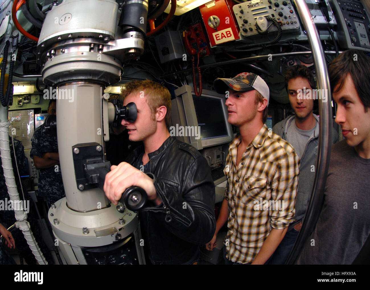 090511-N-7705S-031 NORFOLK (May 11, 2009) Josh Carter of the country music band The Carter Twins peers through the periscope of the Los Angeles-class attack submarine USS Norfolk (SSN 714) as his twin brother Josh looks on. The Carter Twins, currently on tour, were named the fastest rising new country act of 2009 by Country Music Television. The country music stars, their family, and band members made a brief stop at Naval Station Norfolk to visit the submarine before continuing on with their concert tour. (U.S. Navy photo by Mass Communication Specialist 1st Class Todd A. Schaffer/Released) U Stock Photo