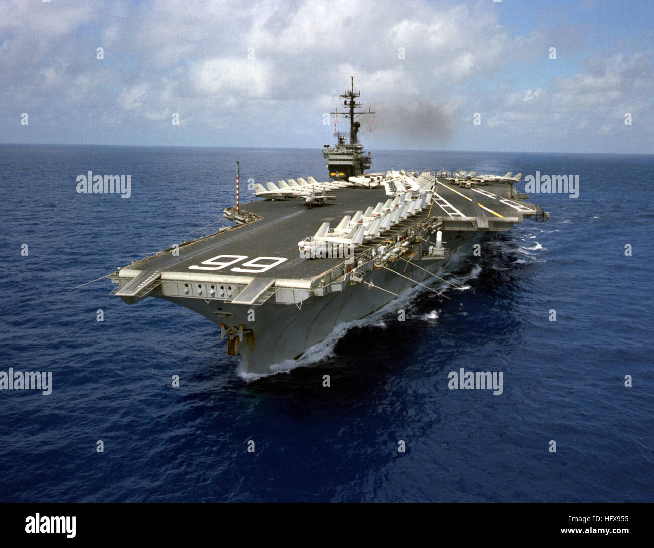 An aerial port view of the Kitty Hawk Class aircraft carrier USS