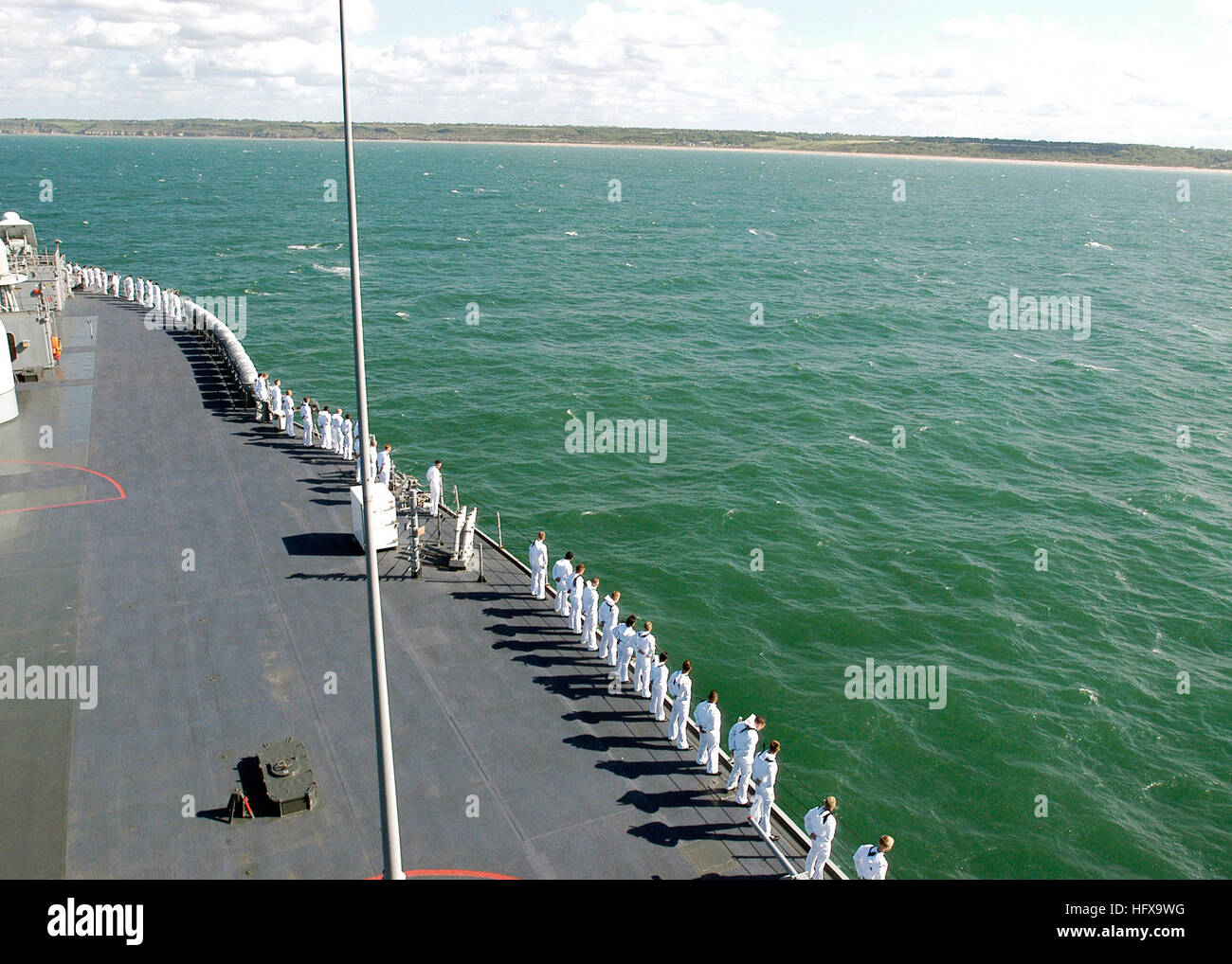 USS Mount Whitney approaches Omaha Beach as her Sailors man the rails. The ship rendered honors to the fallen in remembrance of the 67th anniversary of the Battle of Midway and the 65th anniversary of the Battle of Normandy.  Mount Whitney, the U.S. 6th Fleet flag ship, is in transit to the annual Baltic Operations exercise; the largest international exercise organized in the Baltic Sea.  BALTOPS provides a basis for promoting mutual understanding and maritime interoperability between U.S. Navy, NATO, and non-NATO participants through a series of multilateral training exercises. Mount Whitney  Stock Photo