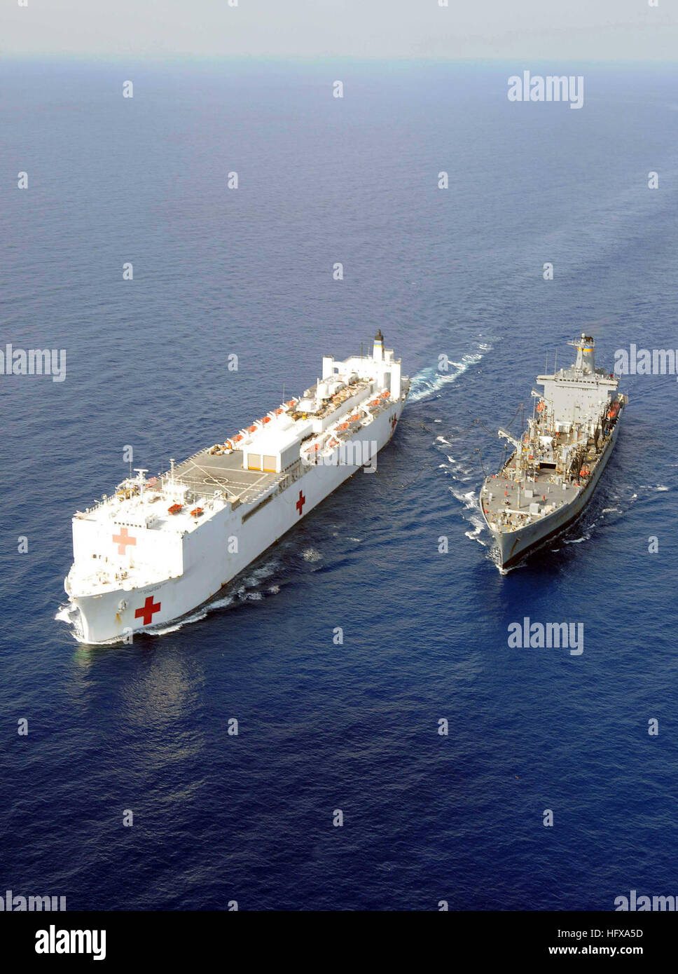 The Military Sealift Command hospital ship USNS Comfort, left, and the ...