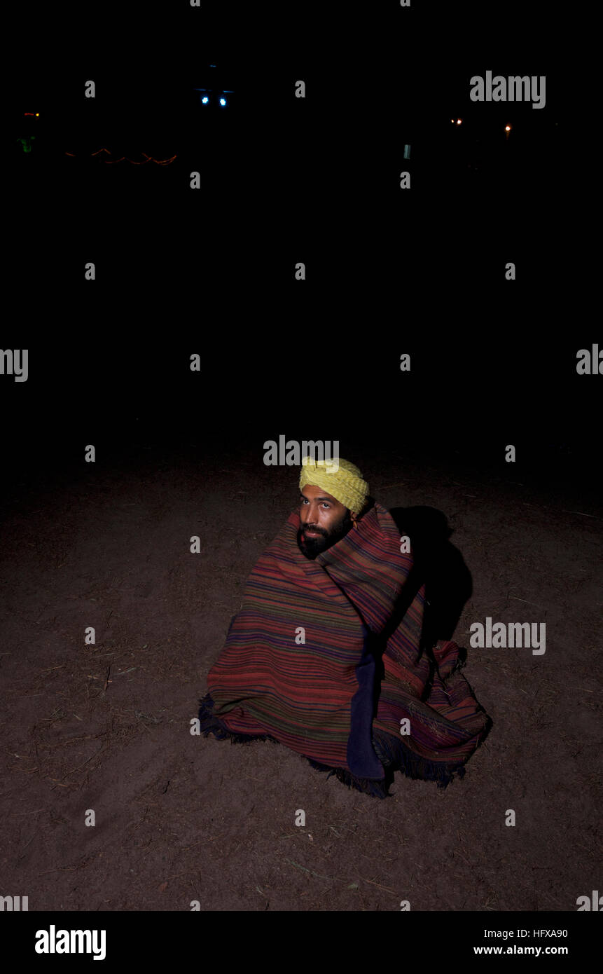 Turbanned man keeps warm under blanket at night Stock Photo Alamy