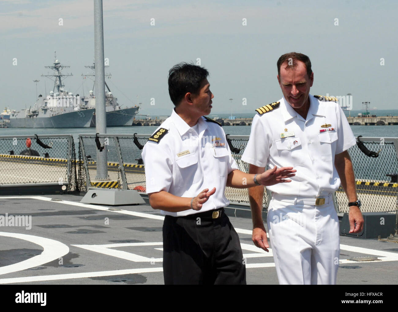 090608-N-8467B-026 SINGAPORE (June 8, 2009) Commodore William A. Kearns III, right, Commander, Task Group 73.5, visits with Col. Wellman Wan, Commander, First Flotilla, Republic of Singapore Navy, aboard the Republic of Singapore Navy frigate RSS Intrepid after the opening ceremony for the Singapore phase of Cooperation Afloat Readiness and Training (CARAT) 2009 at Changi Naval Base. CARAT is a series of bilateral exercises held annually in Southeast Asia to strengthen relationships and enhance the operational readiness of the participating forces. (U.S. Navy photo by Mass Communications Speci Stock Photo