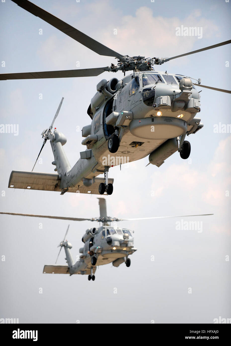 Two MH-60R Sea Hawk helicopters conduct tandem section landings at ...