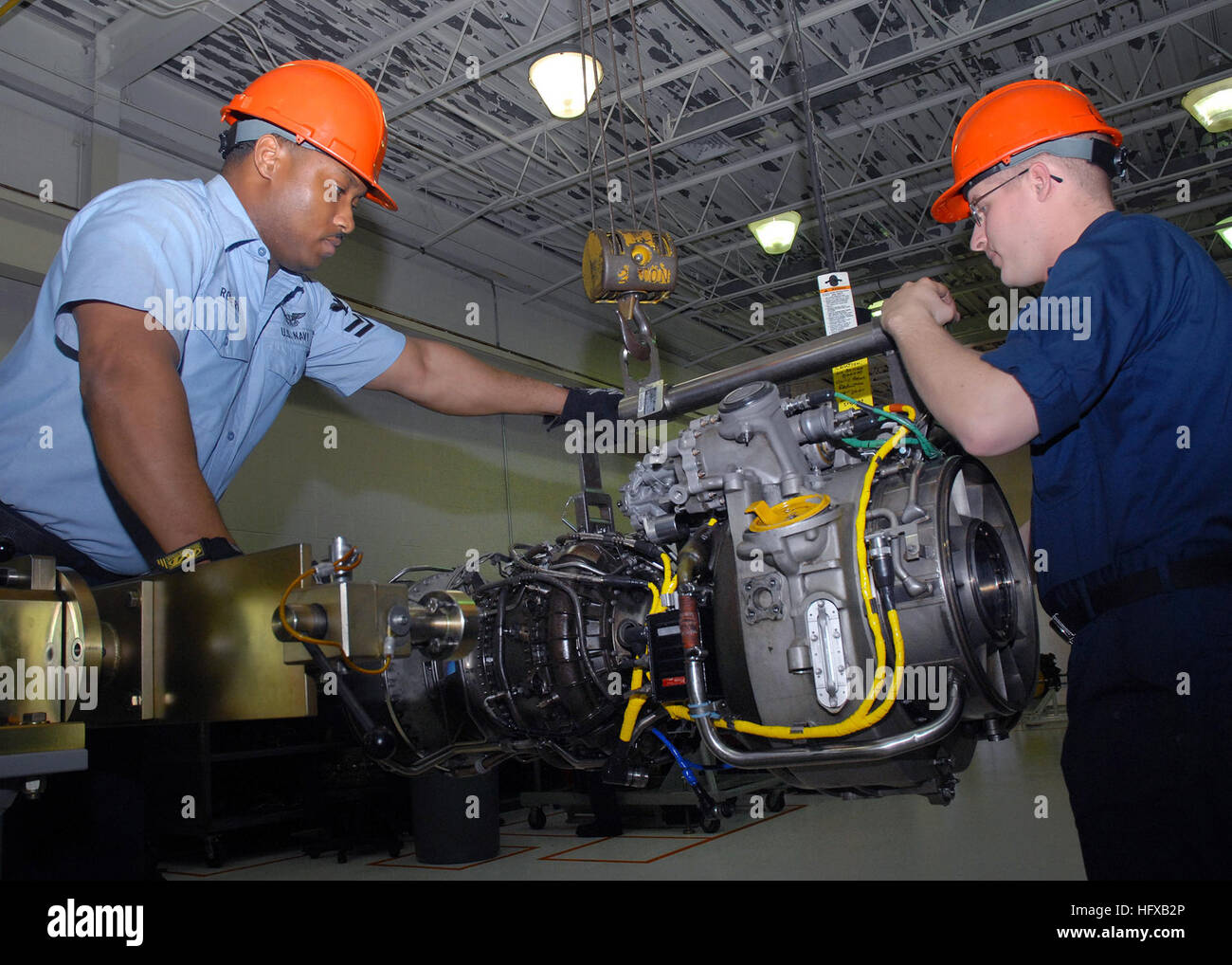 070402-N-1550W-003 MAYPORT, Fla. (April 2, 2007) - Aviation Machinist's Mate 2nd Class James Roberts and Aviation Machinist's Mate Airman Michael Brinkman of Aviation Support Detachment Mayport remove a T-700 engine frame from a maintenance stand for routine maintenance. The T-700 is used to operate HS-60 helicopters. U.S. Navy photo by Mass Communication Specialist 2nd Class Elizabeth Williams (RELEASED) US Navy 070402-N-1550W-003 Aviation Machinist's Mate 2nd Class James Roberts and Aviation Machinist's Mate Airman Michael Brinkman of Aviation Support Detachment Mayport remove a T-700 engi Stock Photo