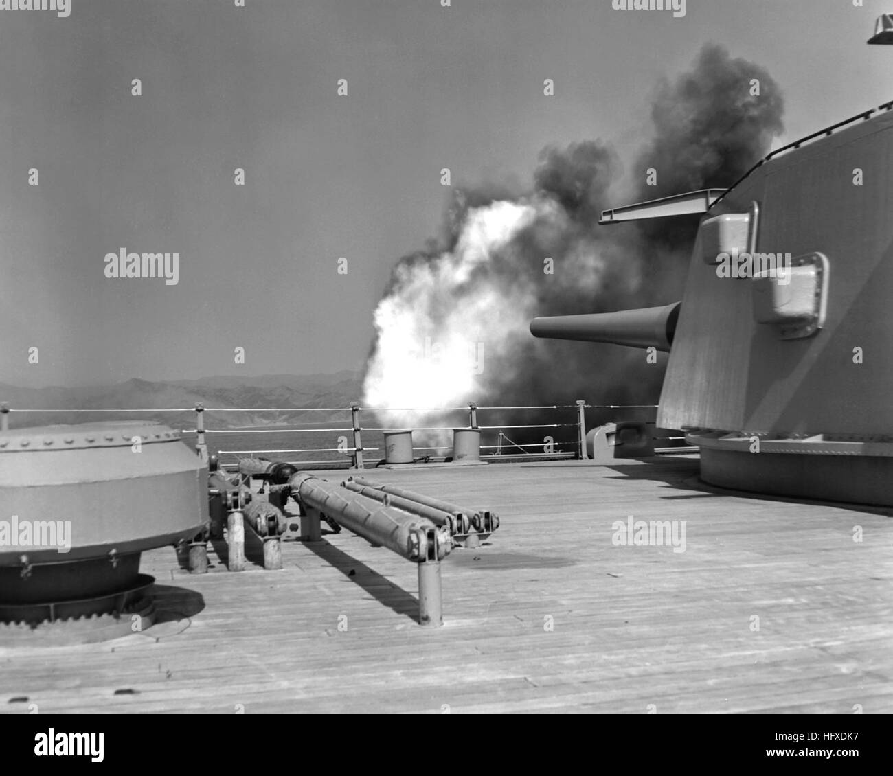 16' shell stopped in flight. NARA FILE #:  80-G-441715 USS New Jersey BB-62 gun firing 1953 Stock Photo