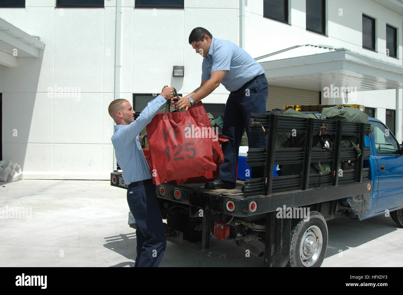050919-N-0000B-001 Key West, Fla. (Sept. 19, 2005) – Sailors assigned to the “Rough Raiders” of Strike Fighter Squadron One Two Five (VFA-125), load support equipment during an ordered evacuation of the Florida Keys and Naval Air Station key West in advance of Hurricane Rita. Visiting squadrons were ordered to evacuate ahead of the category one hurricane, which is expected to pass very near Key West on Tuesday, Sept. 20th. Over two-dozen aircraft and 300 Sailors and Marines departed to air stations north of Key West. U.S. Navy photo by Mr. James Brooks (RELEASED) US Navy 050919-N-0000B-001 Sai Stock Photo