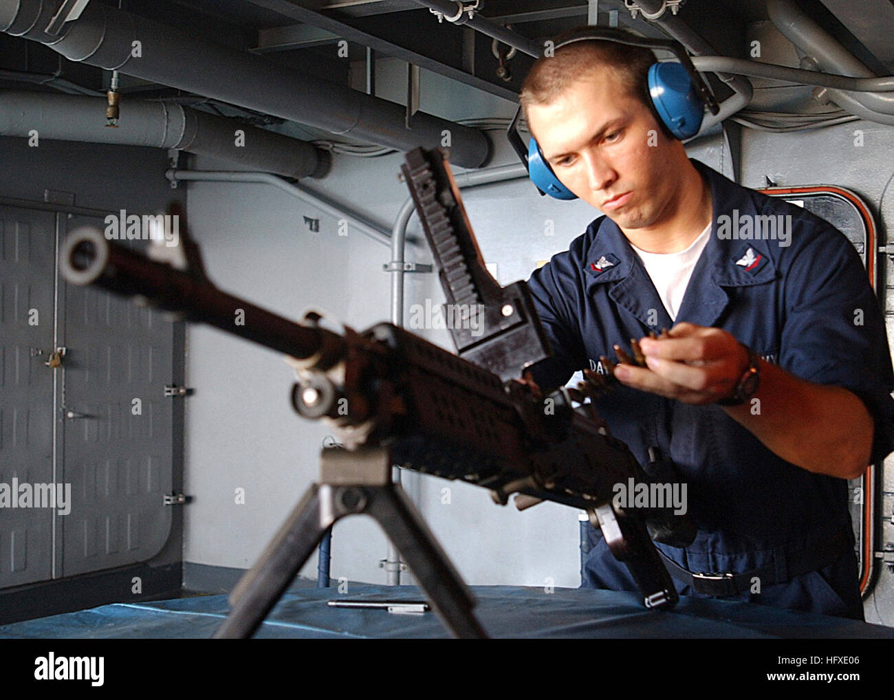 050919-N-0535P-017 Atlantic Ocean (Sept. 19, 2005) - A Sailor practices loading an M-240G medium machine gun during a small arms qualification held aboard the Nimitz-class aircraft carrier USS Harry S. Truman (CVN 75). The M-240 is a 7.62mm, ground-mounted, gas-operated, crew-served machine gun that is replacing the M-60 series machine guns currently in use today. Truman is currently underway conducting routine operations in the Atlantic Ocean. U.S. Navy photo by Photographer's Mate 3rd Class Jay C. Pugh (RELEASED) US Navy 050919-N-0535P-017 A Sailor practices loading an M-240G medium machine  Stock Photo