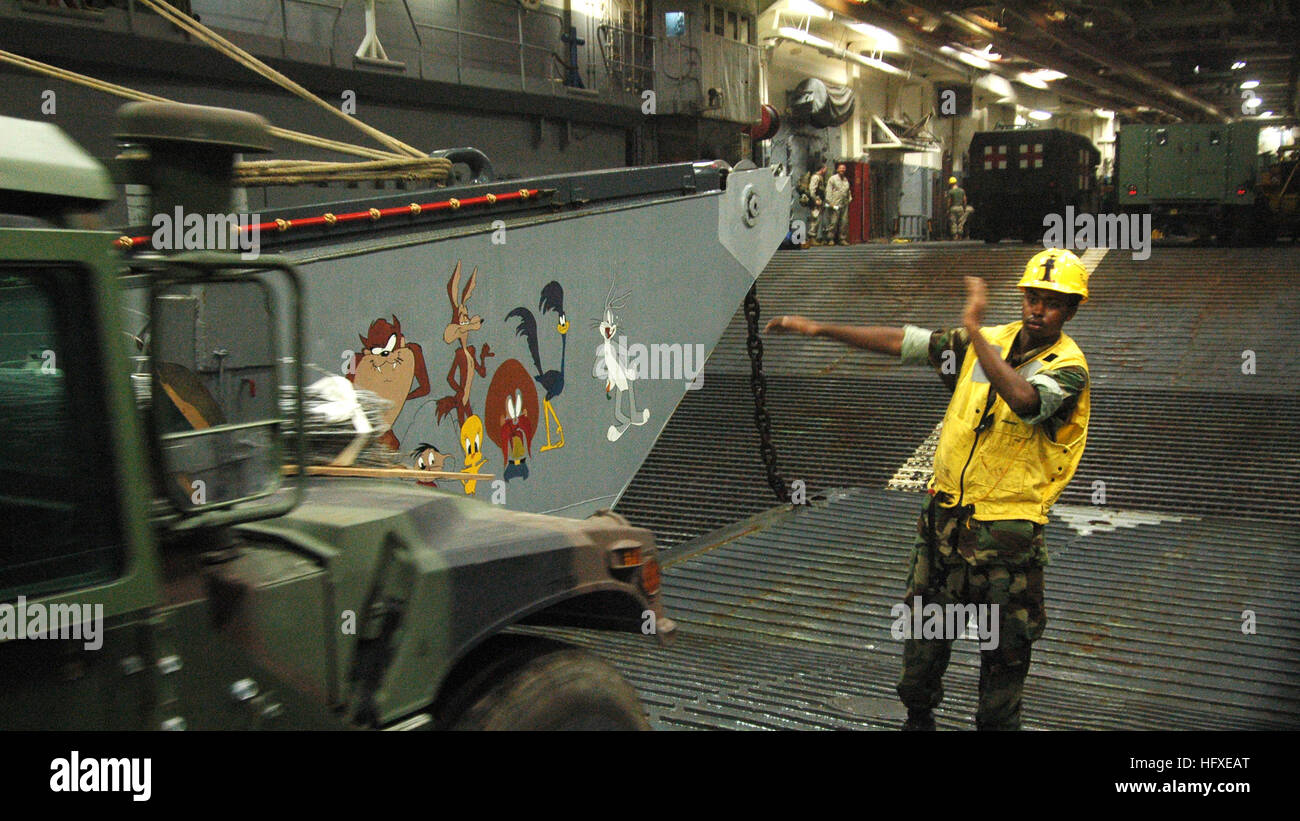 Lcu Ramp Down A Boatswain's Mate 3rd Class directs a HMMWV to back down the ramp of a ...