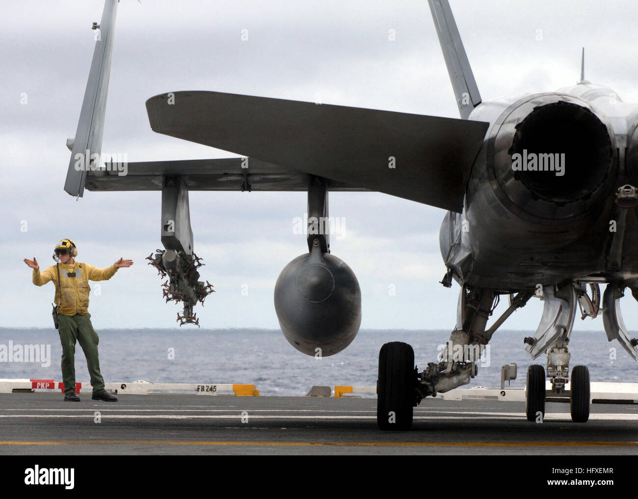 051013-N-4308O-046 Atlantic Ocean (Oct. 13, 2005) - Aviation Boatswain's Mate 3rd Class Joshua McKinney directs an F/A-18C Hornet, assigned to the 'Bulls' of Strike Fighter Squadron Three Seven (VFA-37), across the flight deck of the Nimitz-class aircraft carrier USS Harry S. Truman (CVN 75). Truman is currently conducting carrier qualifications and sustainment training with embarked Carrier Air Wing Three (CVW-3) off the East Coast. U.S. Navy photo by Photographer's Mate 3rd Class Ryan O'Connor (RELEASED) US Navy 051013-N-4308O-046 Aviation Boatswain's Mate 3rd Class Joshua McKinney directs a Stock Photo