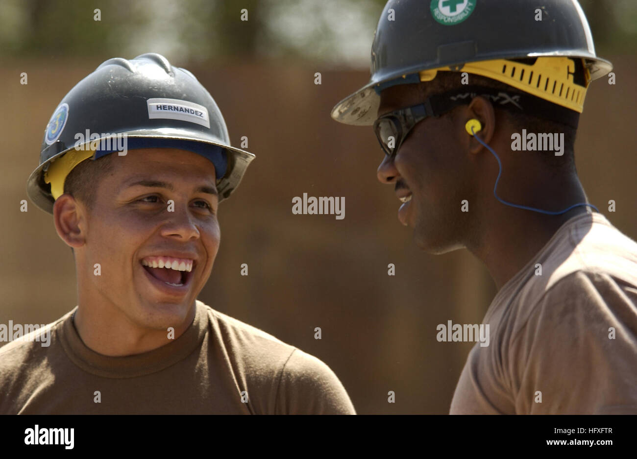 Constructionman Jaime Hernandez, Naval Mobile Construction Battalion 3, talks with his coworker Petty Officer 3rd Class Terence Ruben, Camp Lemonier, Djibouti, Nov. 8, 2005. The two new buildings will be used to combine and house the Joint Task Force-Horn of Africa's Future Operations personnel, who are currently separated in different work tents. (RELEASED) (U.S. Air Force photo by Staff Sgt. Stacy L. Pearsall) US Navy 051108-F-7234P-002 U.S. Navy Constructionman Jaime Hernandez, assigned to Naval Mobile Construction Battalion Three (NMCB-3), speaks with his co-worker, Petty Officer 3rd Class Stock Photo