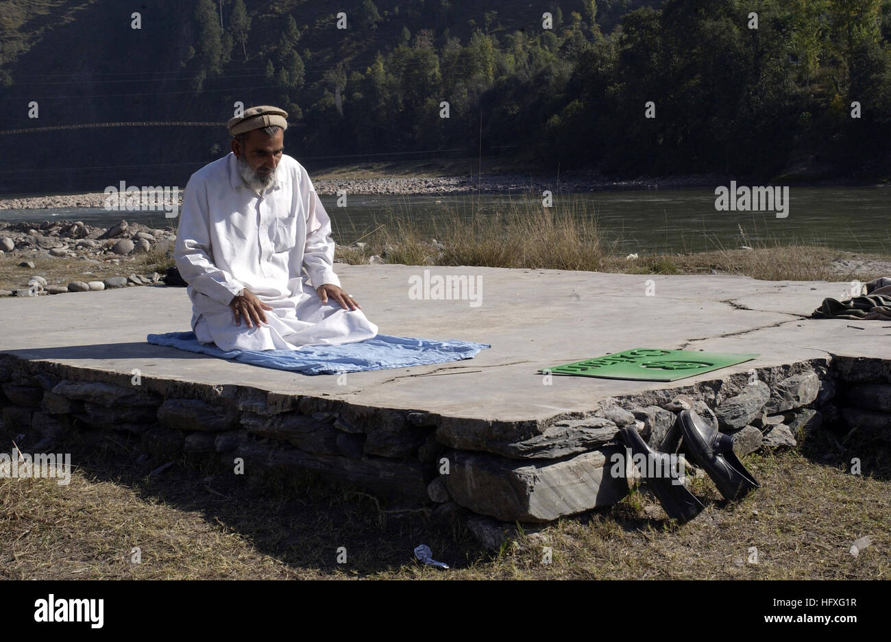 A Pakistani man prays at the Thuri Park tent village mosque in Muzaffarabad, Pakistan, Nov. 13, 2005.  The U.S. government is participating in a multinational humanitarian assistance and support effort lead by the Pakistani government to bring aid to victims of the devastating earthquake that struck the region Oct. 8, 2005.  (U.S. Air Force photo by Airman 1st Class Barry Loo) (Released) US Navy 051113-F-2729L-008 A Pakistani man prays at the Thuri Park Tent Village mosque in Muzaffarabad, Pakistan Stock Photo