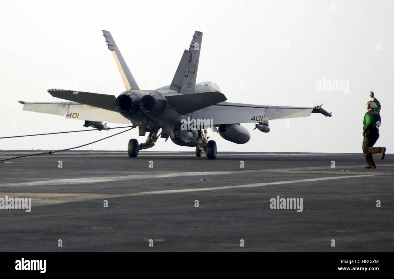051207-N-7571S-002 Persian Gulf (Dec. 7, 2005) - An F/A-18C Hornet, assigned to the 'Golden Warriors' of Strike Fighter Squadron Eight Seven (VFA-87), lands on the flight deck of the Nimitz-class aircraft carrier USS Theodore Roosevelt (CVN 71). Roosevelt and embarked Carrier Air Wing Eight (CVW-8) are currently underway on a regularly scheduled deployment conducting maritime security operations. U.S. Navy photo by Lithographer 3rd Class Jonathan Snyder (RELEASED) US Navy 051207-N-7571S-002 An F-A-18C Hornet, assigned to the Stock Photo