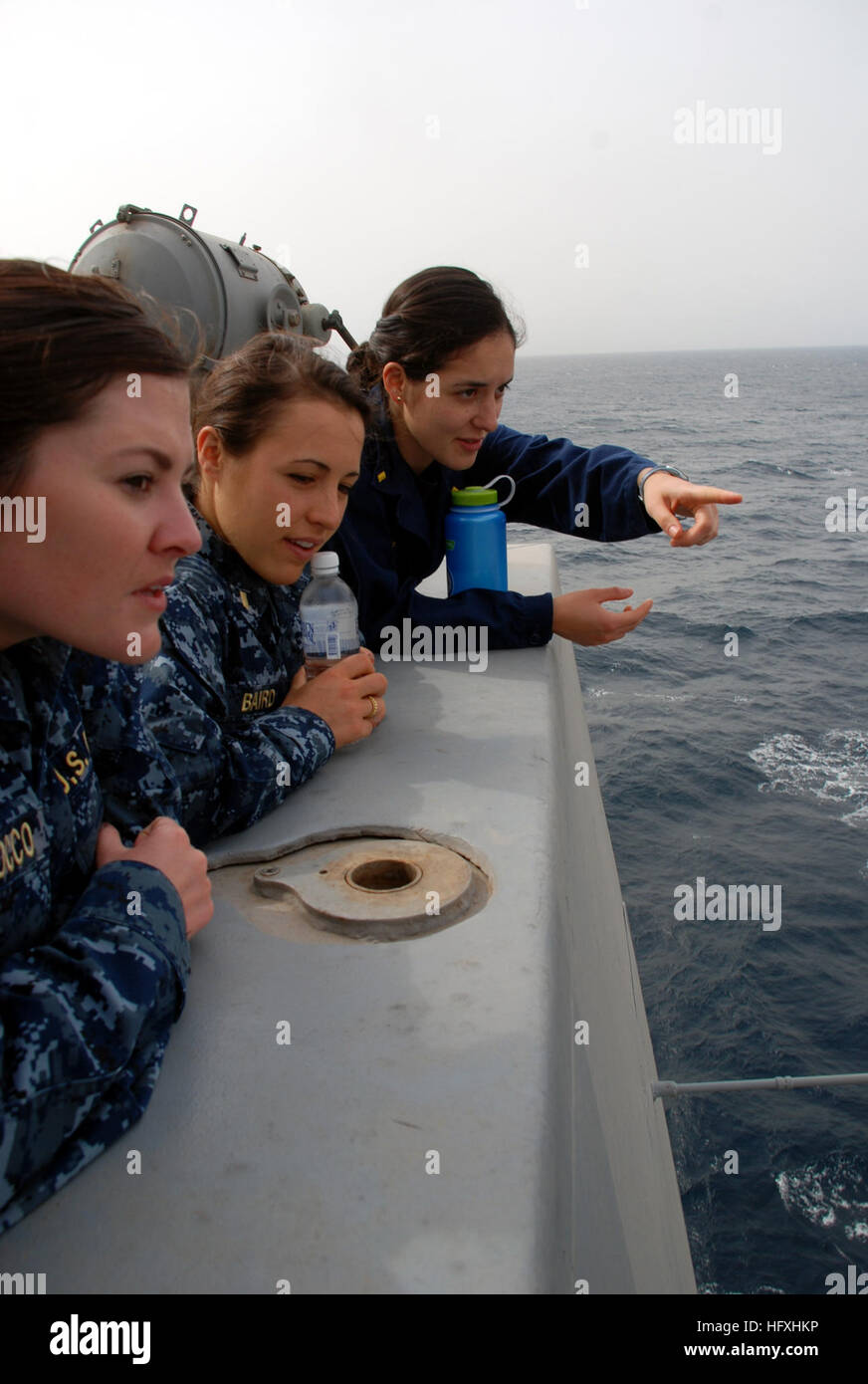 130325-N-BB534-054 U.S. 5TH FLEET AREA OF RESPONSIBILITY (Mar. 25, 2013) Ensign Kathryn Yanez points out features in the boat valley to visiting junior officers Ensign Jane Baird (center) and Ensign Ryan Scirocco aboard the amphibious transport dock ship USS Green Bay (LPD 20).  Green Bay is part of the Peleliu Amphibious Ready Group and, with embarked 15th Marine Expeditionary Unit, is deployed in support of maritime security operations and theater security cooperation efforts in the U.S. 5th Fleet area of responsibility. (U.S. Navy photo by Mass Communication Specialist 1st Class Elizabeth M Stock Photo
