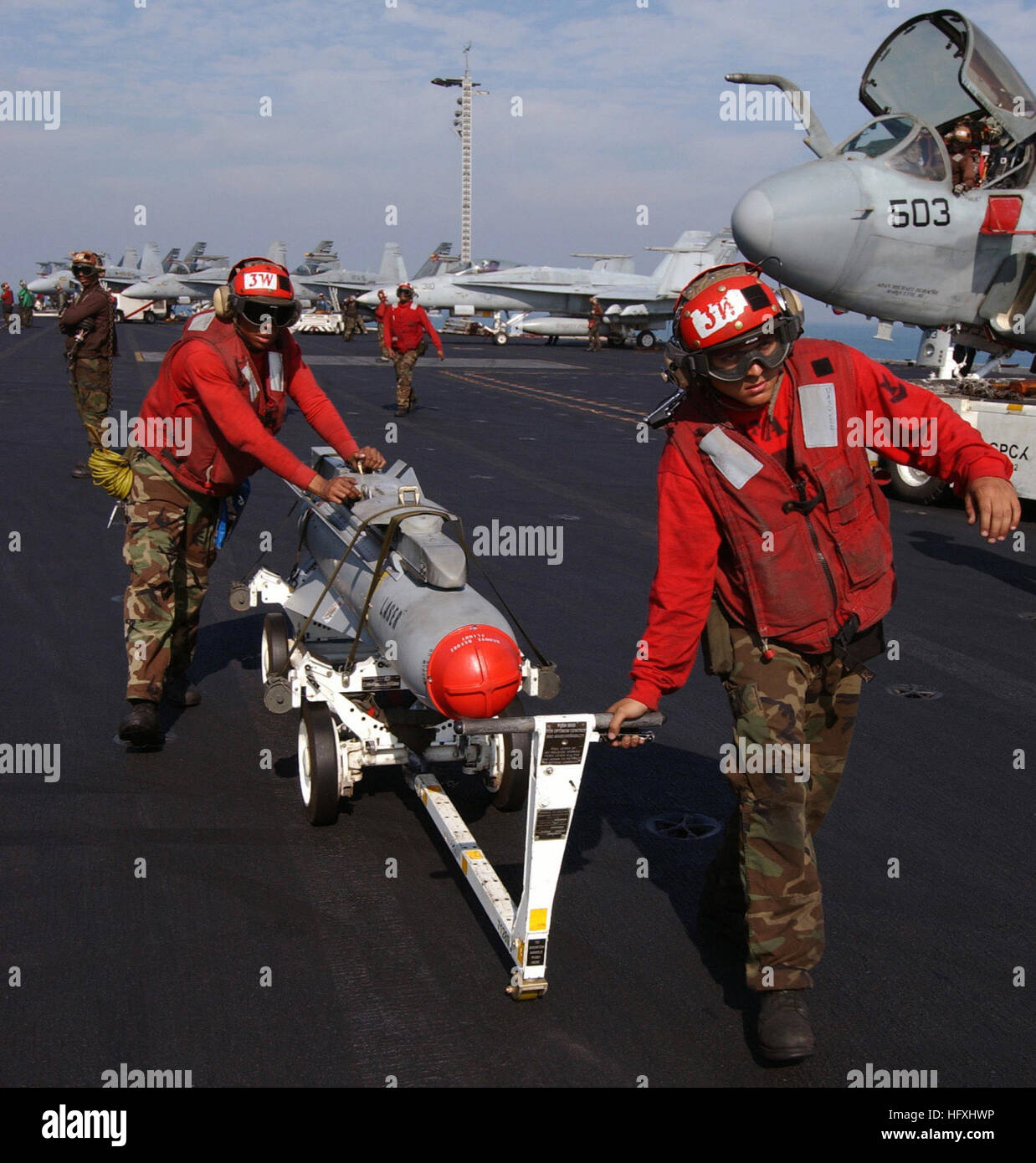 060106-N-7241L-005 Persian Gulf (Jan. 6, 2006) - Aviation Ordnancemen transport an AGM-65 Maverick laser-guided missile after off-loading it from an F/A-18C Hornet aboard the Nimitz-class aircraft carrier USS Theodore Roosevelt (CVN 71). Roosevelt and embarked Carrier Air Wing Eight (CVW-8) are underway on a regularly scheduled deployment conducting maritime security operations. U.S. Navy photo by Photographer's Mate Airman Apprentice Nathan Laird (RELEASED) US Navy 060106-N-7241L-005 Aviation Ordnancemen transport an AGM-65 Maverick laser-guided missile after off-loading it from an F-A-18C Ho Stock Photo