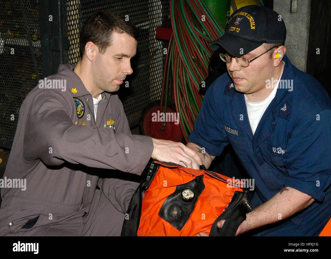 060110-N-9898L-013  Naval Air Station North Island (Jan. 10, 2006) - A member of an Inspection Survey (INSURV) team checks the condition of safety equipment in the hanger bay aboard the Nimitz- class aircraft carrier USS Abraham Lincoln (CVN 72). Lincoln is at North Island for the purpose of a Board of Inspection and Survey. U.S. Navy photo by Photographer's Mate Airman Geoffrey Lewis (RELEASED) US Navy 060110-N-9898L-013 A member of an Inspection Survey (INSURV) team checks the condition of safety equipment in the hanger bay Stock Photo