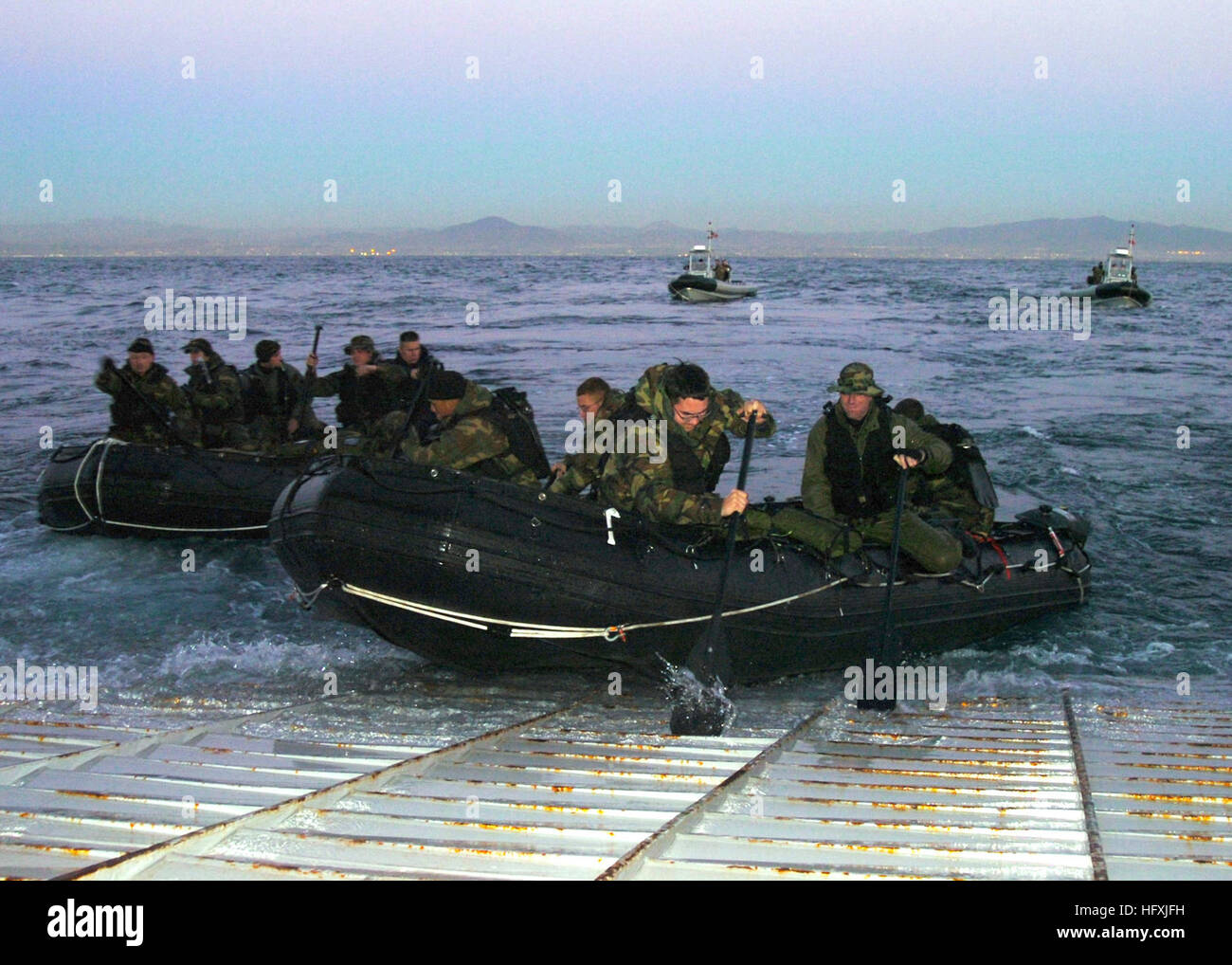 060120-N-7027P-107 Pacific Ocean (Jan. 19, 2006) - Personnel assigned to U.S. Naval Special Clearance Team One (NSCT-1) deploy their combat rubber raiding crafts F-580 (CRRC) off the stern gate of the amphibious dock landing ship USS Comstock (LSD 45). NSCT-1 is currently conducting mine counter measure training operations. U.S. Navy photo by Photographer's Mate 2nd Class Sandra M. Palumbo (RELEASED) US Navy 060120-N-7027P-107 Personnel assigned to U.S. Naval Special Clearance Team One (NSCT-1) deploy their combat rubber raiding crafts F-580 (CRRC) off the stern gate Stock Photo