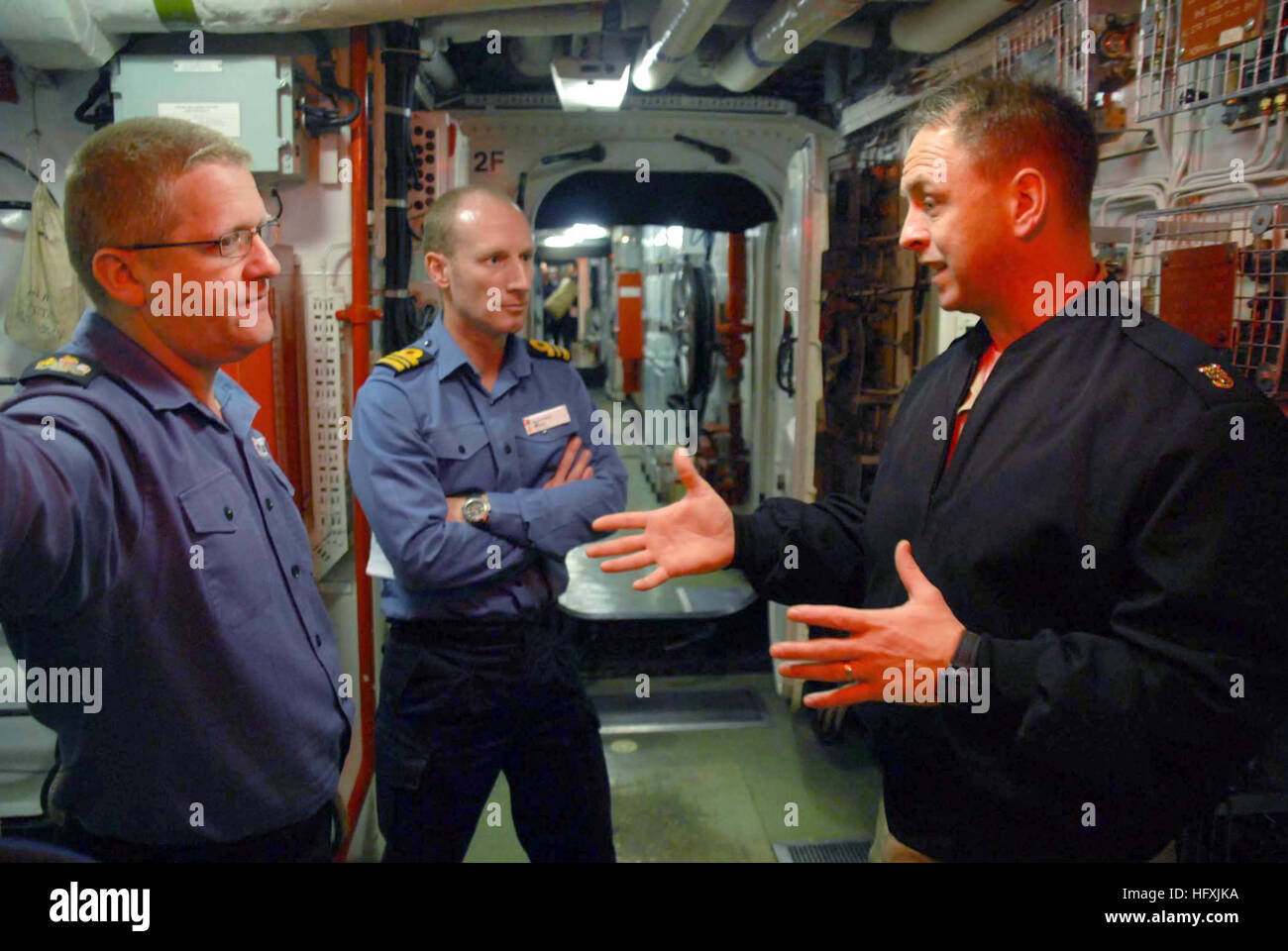 070125-N-3888C-001 Aegean Sea (Jan. 25, 2007) - Master Chief Operations Specialist Aaron David Blair, operations department leading chief petty officer assigned to guided missile cruiser USS Monterey (CG 61), discuses damage control procedures with Executive Warrant Officer Dicky Bays and Lt. Cmdr. N.J. Baker aboard Royal Navy frigate HMS Montrose (F236) during a cross deck visit. Monterey and Montrose are components of Standing NATO Maritime Group Two (SNMG-2) and are currently conducting operations in support of Operation Active Endeavor. U.S. Navy photo (RELEASED) US Navy 070125-N-3888C-00 Stock Photo