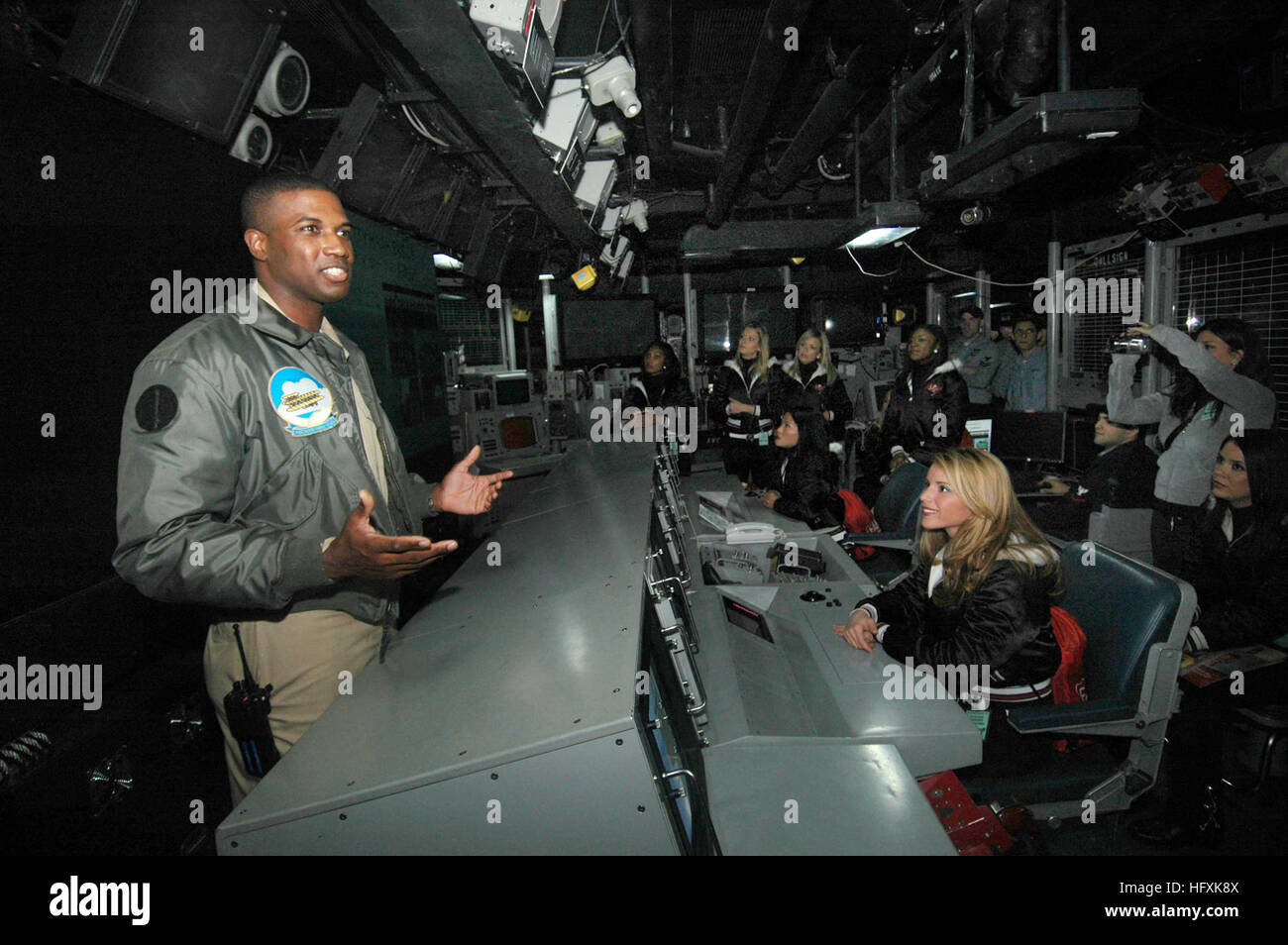 070209-N-7883G-011 Yokosuka, Japan (Feb. 9, 2007) - Lt. Arnold Roper, from Philadelphia, briefs the Tampa Bay Buccaneers Cheerleaders on the daily routine inside USS Kitty Hawk's (CV 63) Combat Direction Center (CDC). As part of the 2007 Military Appreciation Tour, the Tampa Bay Buccaneers Cheerleaders are touring various military installations throughout Asia. U.S. Navy photo by Mass Communication Specialist Seaman Kyle D. Gahlau (RELEASED) US Navy 070209-N-7883G-011 Lt. Arnold Roper, from Philadelphia, briefs the Tampa Bay Buccaneers Cheerleaders on the daily routine inside USS Kitty Hawk (C Stock Photo