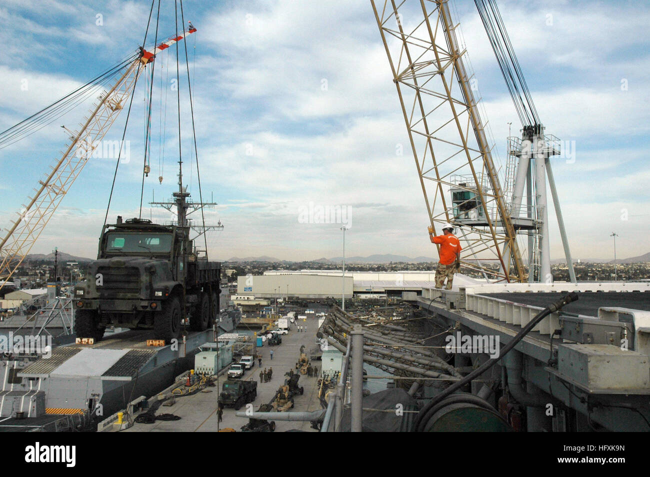 060208-N-5764B-007 San Diego (Feb. 9, 2006) - Combat Cargo Marines use a crane to load equipment onto the amphibious assault ship USS Peleliu (LHA 5) for a scheduled deployment in support of the global war on terrorism. U.S. Navy photo by Lithographer 1st Class John Banfield (RELEASED) US Navy 060208-N-5764B-007 Combat Cargo Marines use a crane to load equipment onto the amphibious assault ship USS Peleliu (LHA 5) for a scheduled deployment in support of the global war on terrorism Stock Photo
