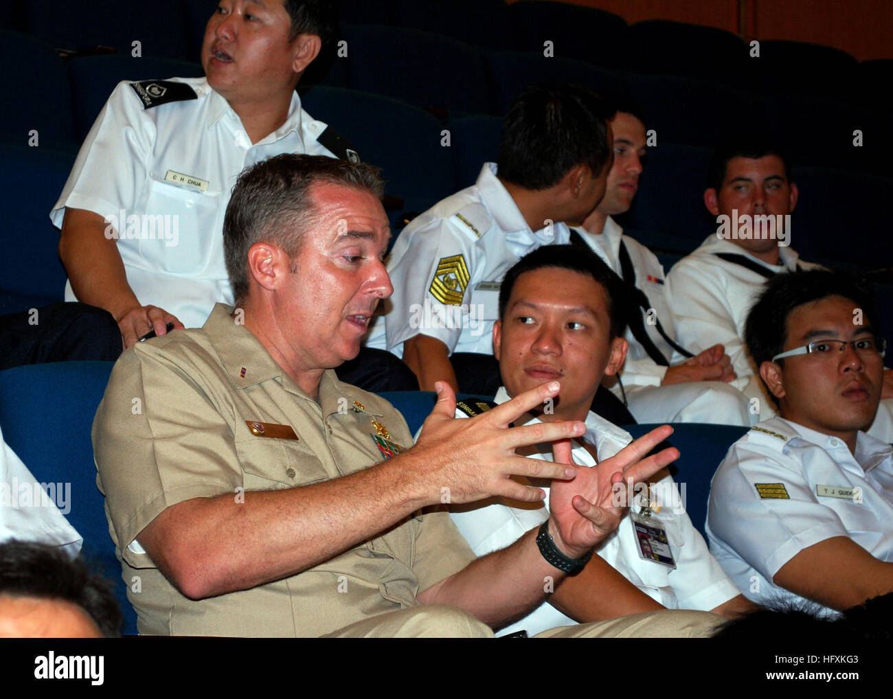090619-N-0869H-017 SINGAPORE (June 19, 2009) Chief Warrant Officer Troy Roat, assigned to Mobile Diving and Salvage Unit (MDSU) 1, Company 14, speaks with a Republic of Singapore Navy officer during the closing ceremony of the Singapore phase of Cooperation Afloat Readiness and Training (CARAT) 2009. CARAT is a series of bilateral exercises held annually in Southeast Asia to strengthen relationships and enhance the operational readiness of the participating forces. (U.S. Navy photo by Senior Chief Mass Communication Specialist Susan Hammond/Released) US Navy 090619-N-0869H-017 Chief Warrant Of Stock Photo