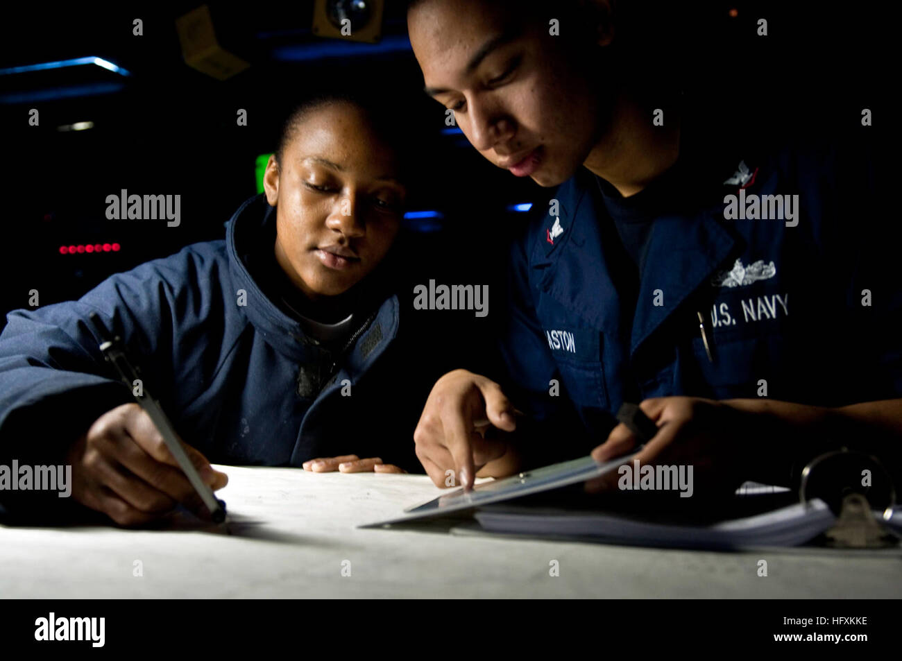 100219-N-5712P-047 ATLANTIC OCEAN (Feb. 19, 2010) Operations Specialist 2nd Class Jodi Ann Miller, from Kingston, Jamaica, and Operations Specialist 3rd Class Josean Gaston, from Fayetteville, N.C., plot a course on the map charts before the amphibious assault ship USS Nassau (LHA 4) transits the Strait of Gibraltar. Nassau is deployed as part of the Nassau Amphibious Readiness Group with embarked Marines from the 24th Marine Expeditionary Unit (24th MEU) supporting maritime and theatre security operations and in the U.S. 5th and 6th Fleet areas of responsibility. (U.S. Navy photo by Mass Comm Stock Photo