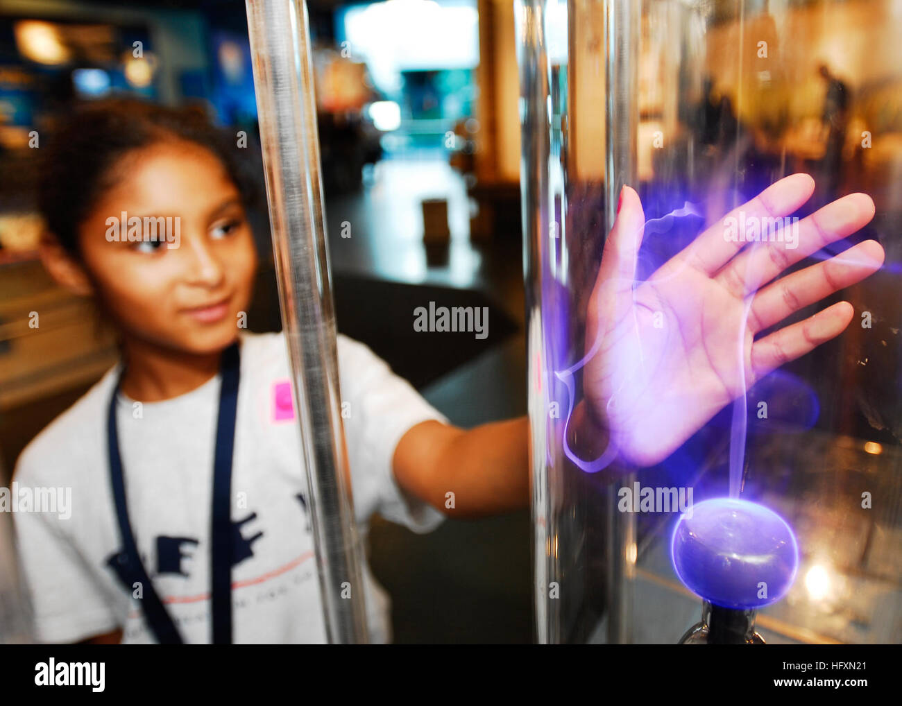 090714-N-2456S-049 NORFOLK, Va. (July 14, 2009) Nine year old, Kaitlynn Walker places her hand on the glass casing of a plasma ball at the Hampton Roads Naval Museum. Drug Education for Youth (DEFY) is a week-long program designed to provide students awareness about the dangers of drugs and alcohol. (U.S. Navy photo by Mass Communication Specialist 3rd Class John Suits/Released) US Navy 090714-N-2456S-049 Nine year old, Kaitlynn Walker places her hand on the glass casing of a plasma ball at the Hampton Roads Naval Museum Stock Photo