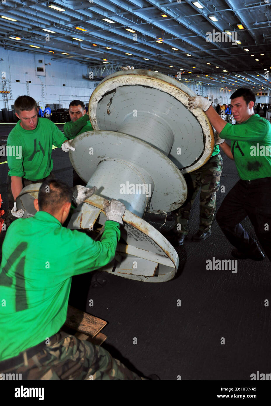 100718-N-0569K-126 ATLANTIC OCEAN (July 18, 2010) Sailors assigned to the Air department of the aircraft carrier USS Enterprise (CVN 65) move a spool that holds the number two arresting gear wire. Enterprise is on a scheduled underway for fleet replacement squadron carrier qualifications and is making preparations for its 21st deployment. (U.S. Navy photo by Mass Communication Specialist Seaman Apprentice Jared M. King/Released) US Navy 100718-N-0569K-126 Sailors assigned to the Air department of the aircraft carrier USS Enterprise (CVN 65) move a spool that holds the number two arresting gear Stock Photo