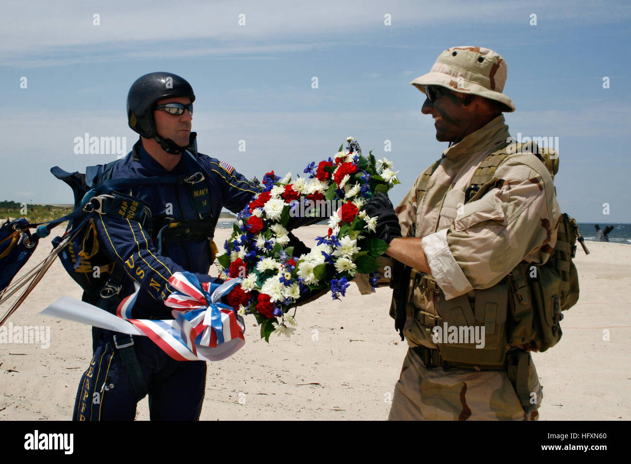 A Navy SEAL parachute team member presents a wreath to honor fallen SEALs during the East Coast SEAL Reunion at Little Creek Naval Amphibious Base, with ceremonial wreath placement at sea and