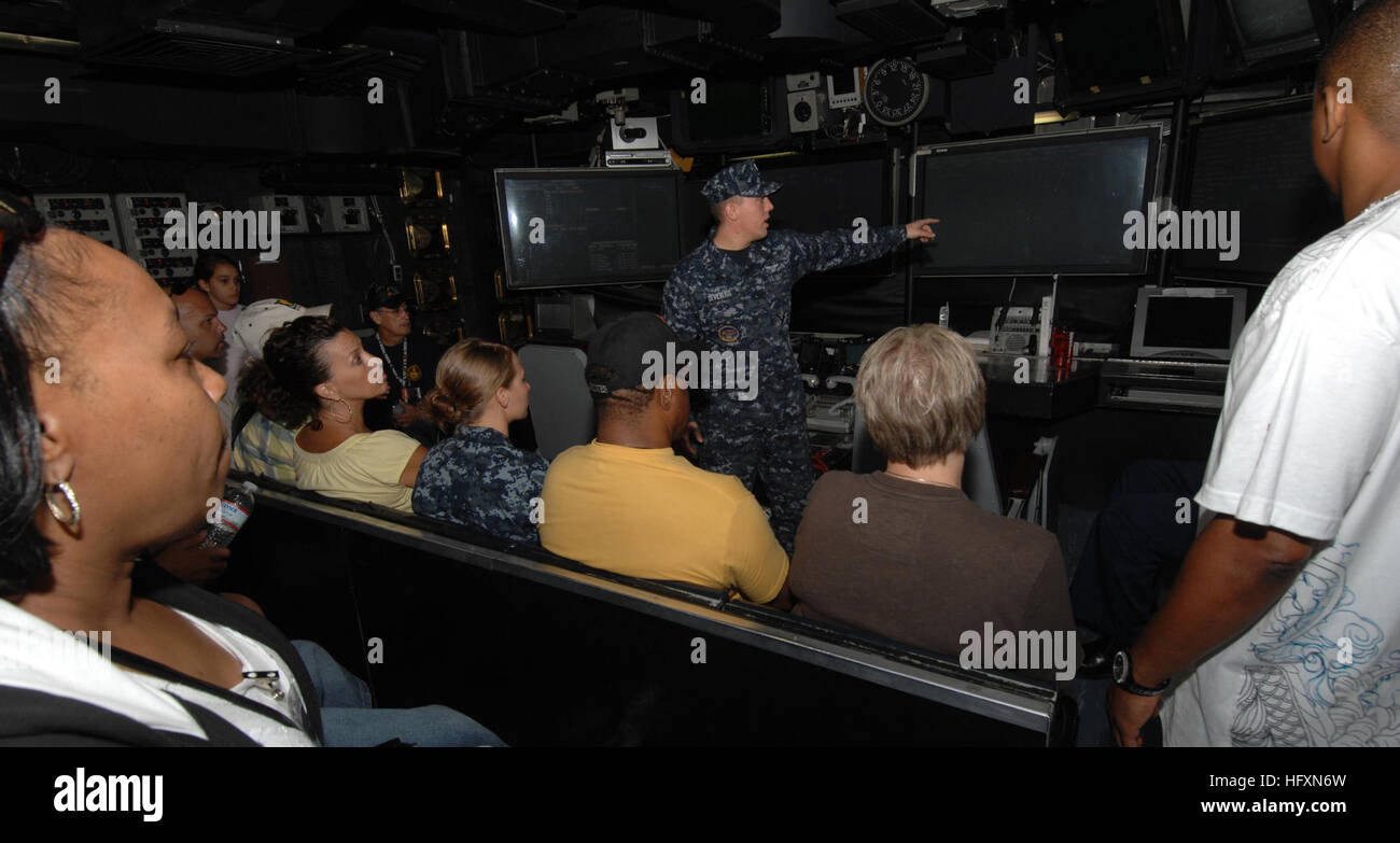 Friends and family listen to Air Traffic Controller 3rd Class (AW) Chris Devilbliss give them a brief of how things operate in CATCC (Carrier Air Traffic Control Center) onboard the aircraft carrier USS Harry S. Truman (CVN 75) during Truman's Friends and Family Day Cruise 2009. Approximately 3,700 friends and family of Truman Sailors joined the crew for a 14-hour underway to see a day in the life aboard an aircraft carrier. (U.S. Navy photo by Mass Communication Specialist Third Class Daron Street/Released) USS Harry S. Truman 090718-N-NG658-003 Stock Photo
