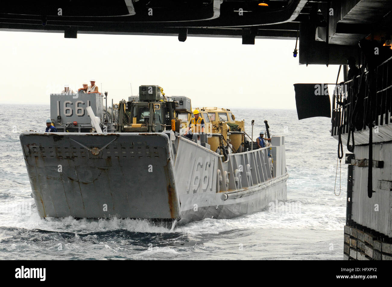 Landing Craft Utility 1661 enters the well deck of the amphibious ...
