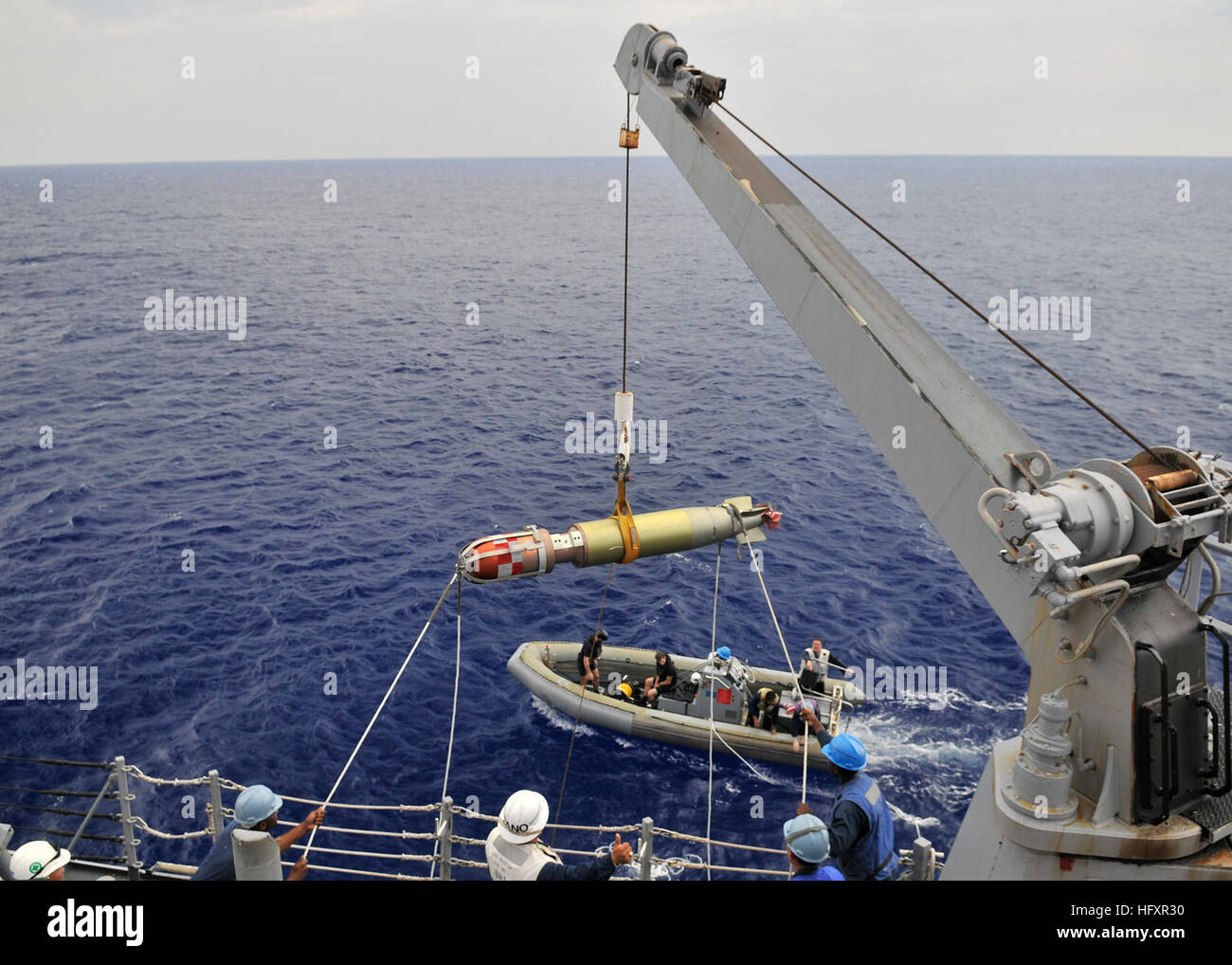 A MK-46 recoverable exercise torpedo (REXTORP) is lifted aboard the ...