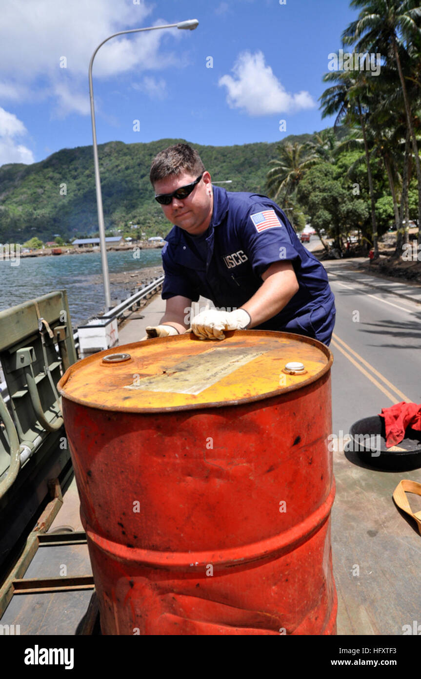 091003-F-3798Y-136 PAGO PAGO (Oct. 3, 2009) U. S. Coast Guard Marine Science Technician 2nd Class Ryan Erpelding, assigned to U.S. Coast Guard Sector Hawaii, moves a barrel with hazardous waste towards the back of a truck in Pago Pago, American Samoa. Coast Guardsmen attached to U.S. Coast Guard Sector Hawaii, Soldiers from U. S. Army National Guard Hawaii and Environmental Protection Agency officials are searching along the coastline and inland for hazardous materials which might have been carried away after an earthquake and resulting tsunami struck the region. (U.S. Air Force photo by Tech  Stock Photo