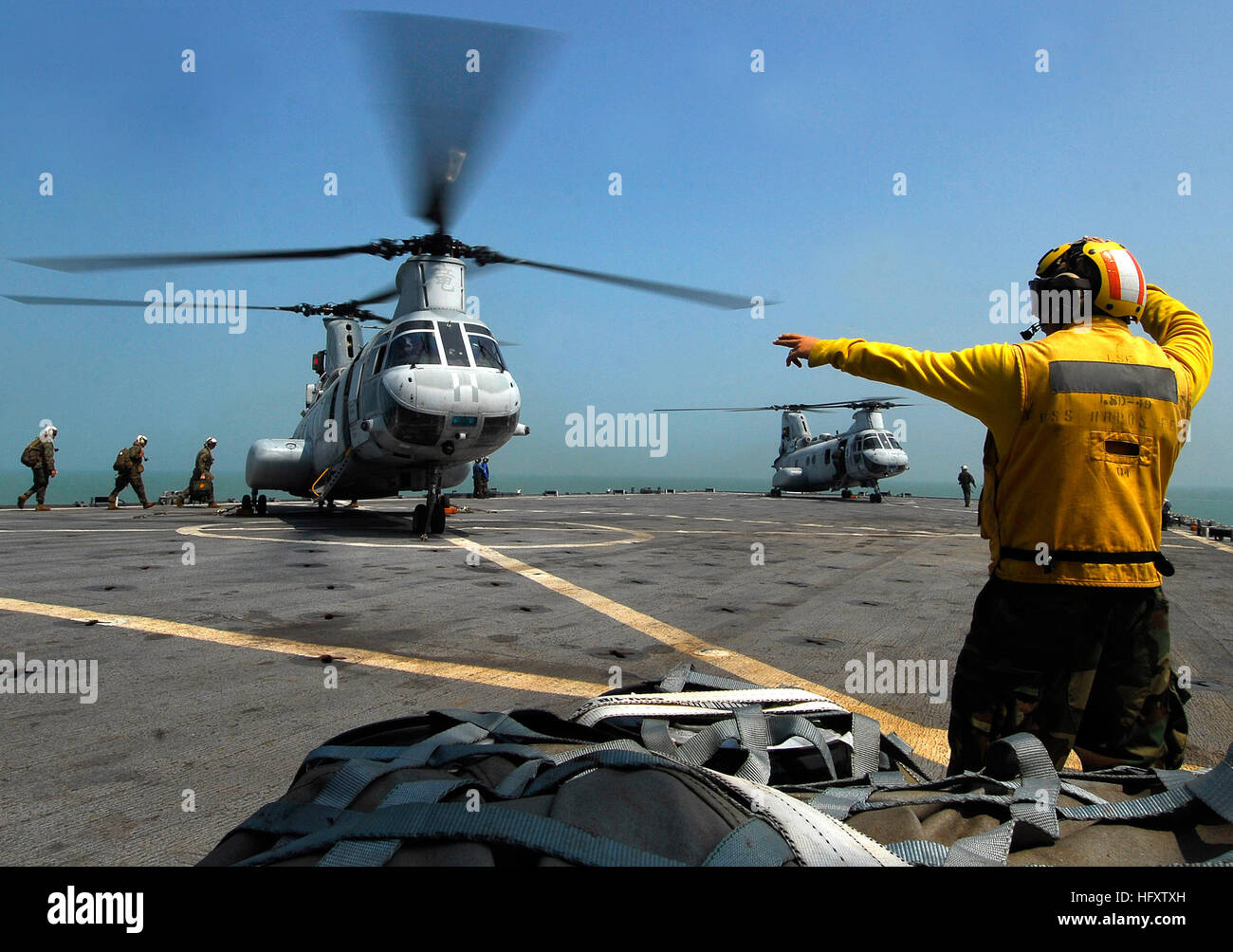 091011-N-0807W-021  SOUTH CHINA SEA (Oct. 11, 2009) Boatswain's Mate 3rd Class Kyle E. Eggering directs Navy and Marine Corps personnel aboard a Marine Corps CH-46 helicopter during flight operations aboard the the amphibious dock landing ship USS Harpers Ferry (LSD 49). Harpers Ferry, the amphibious dock  landing ship USS Tortuga (LSD 46) and the 31st Marine Expeditionary Unit (MEU) are supporting humanitarian assistance operations at the request of the Republic of the Philippines in the wake of Typhoon Parma. (U.S. Navy photo by Mass Communication Specialist 2nd Class Joshua J. Wahl/Released Stock Photo
