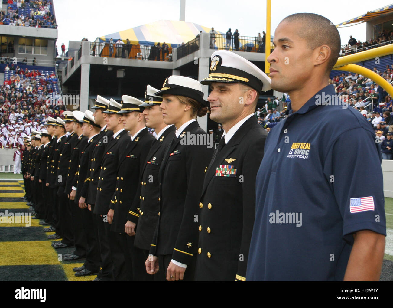 091030-N-5366K-174 ANNAPOLIS, Md. (Oct. 31, 2009) Special Warfare Operator 1st Class (SEAL) David Goggins stands at attention with members of the U.S. Naval Academy's triathlon team as they are recognized as Collegiate National Champions at the Navy-Marine Corps Stadium during a football game. The team named Goggins an honorary team member during the event. (U.S. Navy photo by Mass Communication Specialist 2nd Class Michelle Kapica/Released) US Navy 091030-N-5366K-174 Special Warfare Operator 1st Class (SEAL) David Goggins stands at attention with members of the U.S. Naval Academy's triathlon  Stock Photo