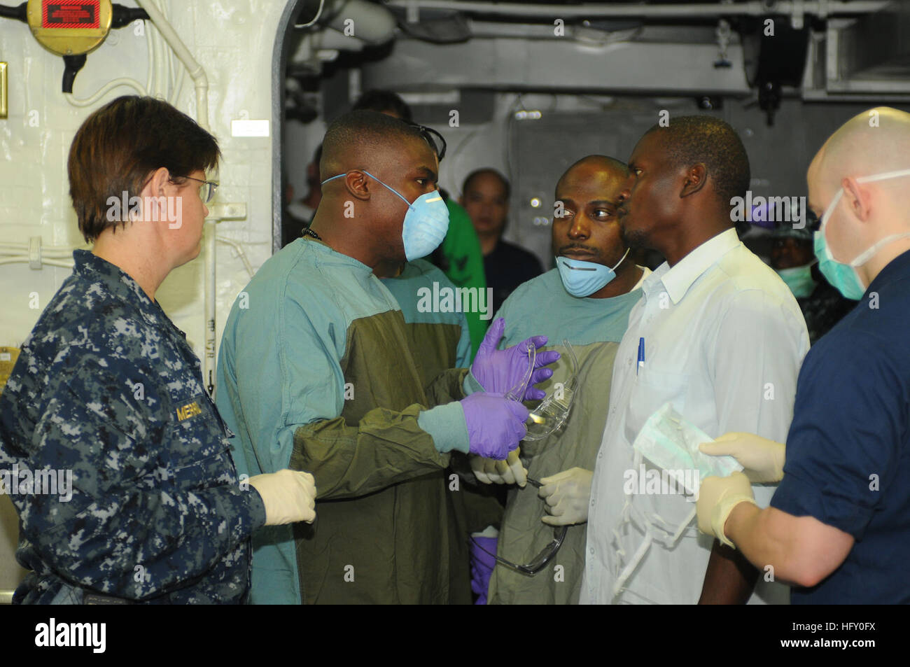 100119-N-1831S-062 PORT-AU-PRINCE, Haiti (Jan. 19, 2010) A Haitian man speaks with the medical staff aboard the multi-purpose amphibious assault ship USS Bataan (LHD 5) about his mother's condition. His 70-year-old mother was freed from a collapsed building Jan. 19, after being trapped under rubble for seven days. Bataan is supporting Operation Unified Response, a joint operation providing humanitarian assistance following a 7.0 magnitude earthquake that struck Haiti Jan. 12, 2010. (U.S. Navy photo by Mass Communication Specialist 3rd Class Ash Severe/Released) US Navy 100119-N-1831S-062 A Hai Stock Photo