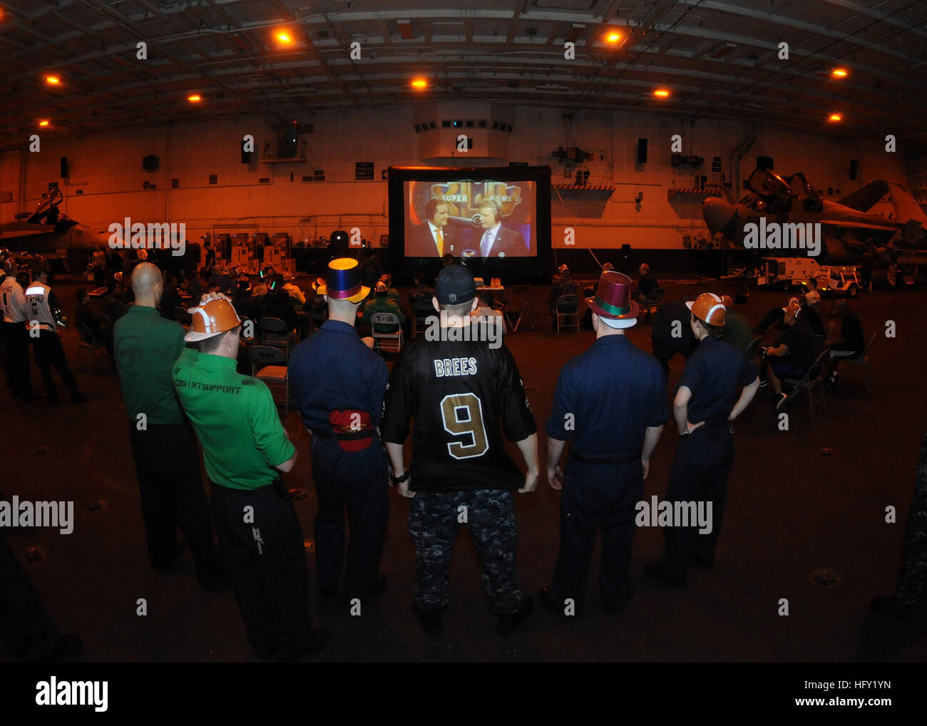 100208-N-4236E-029  GULF OF OMAN (Feb. 8 2010) Sailors wait for Super Bowl XLIV to begin during an early-morning Super Bowl party in the hanger bay of the Nimitz-class aircraft carrier USS Dwight D. Eisenhower (CVN 69). Dwight D. Eisenhower is deployed as part of an on-going rotation of forward-deployed forces to support maritime security operations in the U.S. 5th fleet area of responsibility. (U.S. Navy photo by Mass Communication Specialist 3rd Class Chad R. Erdmann/Released) US Navy 100208-N-4236E-029 Sailors wait for Super Bowl XLIV to begin during an early-morning Super Bowl party in the Stock Photo