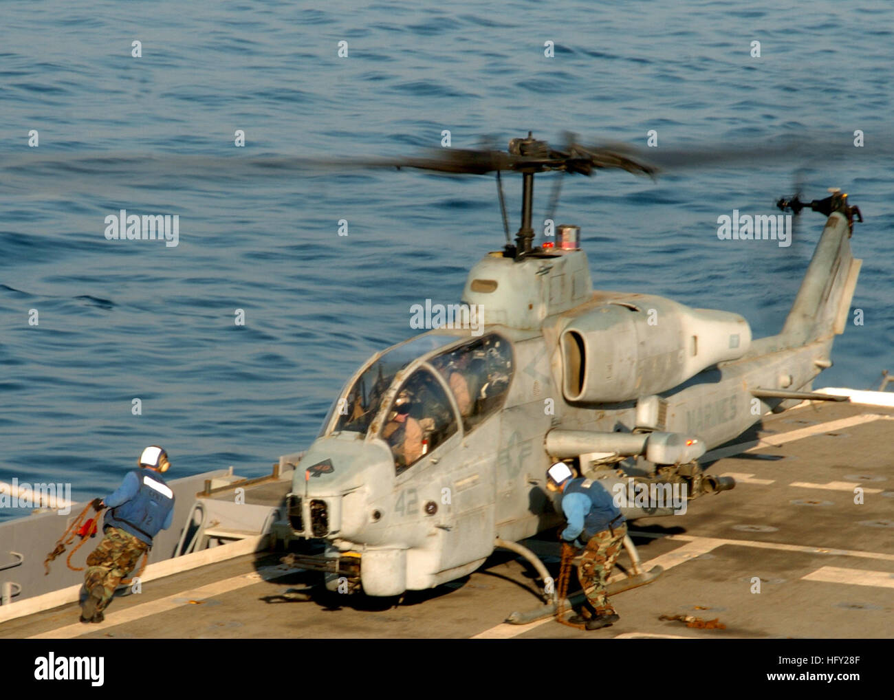 Sailors aboard amphibious transport dock USS Cleveland secure an AH-1W Super Cobra from Marine Medium Helicopter Squadron 166 to the ship's flight deck after the attack helicopter participated in a maritime infrastructure defense exercise with six U.S. and coalition surface combatants operating near the Khawr Al Amaya Oil Terminal in the North Arabian Gulf. Cleveland is part of the Bonhomme Richard Amphibious Ready Group and 11th Marine Expeditionary Unit, currently supporting Maritime Security Operations in the U.S. 5th area of operations. (U.S. Navy photo by Mass Communication Specialist 1st Stock Photo