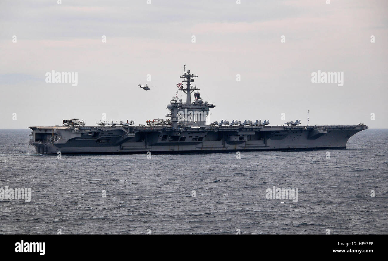 100308-N-4774B-748 ATLANTIC OCEAN (March 8, 2010) A helicopter flies over the Nimitz-class aircraft carrier USS Carl Vinson (CVN 70) during Southern Seas 2010. Southern Seas is a  U.S. Southern Command-directed operation that provides U.S. and international forces the opportunity to operate in a multi-national environment. (U.S. Navy photo by Mass Communication Specialist 2nd Class Daniel Barker/Released) US Navy 100308-N-4774B-748 A helicopter flies over the Nimitz-class aircraft carrier USS Carl Vinson (CVN 70) during Southern Seas 2010 Stock Photo