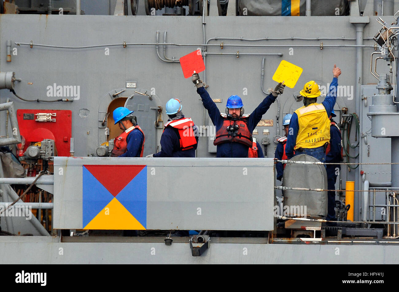 100319-N-4774B-016  PACIFIC OCEAN (March 19, 2010) Merchant Marines aboard the Military Sealift Command fast-combat support ship USNS Rainier (T-AOE 7) signal to Sailors aboard the guided-missile cruiser USS Bunker Hill (CG 52) during a replenishment at sea. Bunker Hill is supporting Southern Seas 2010, a U.S. Southern Command-directed operation that provides U.S. and international forces the opportunity to operate in a multi-national environment. (U.S. Navy photo by Mass Communication Specialist 2nd Class Daniel Barker/Released) US Navy 100319-N-4774B-016 Merchant Mariners aboard the Military Stock Photo