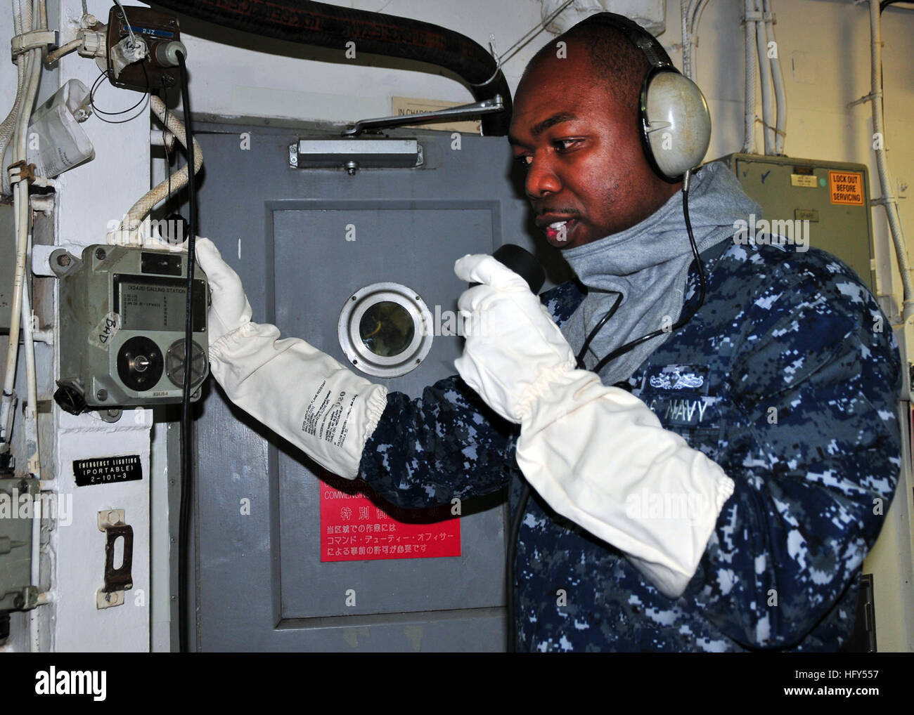111117-N-GE301-009 POLARIS POINT, Guam (Nov. 17, 2011)  Interior Communications Electrician 1st Class Kevin Sampson, assigned to the submarine tender USS Frank Cable (AS 40), establishes communications as part of his duties as phone talker during a casualty drill on the ship.  Frank Cable conducts maintenance and support of submarines and surface vessels deployed in the 7th Fleet area of responsibility. (U.S. Navy photo by Mass Communication Specialist 2nd Class Gabrielle Blake/Released) US Navy 111117-N-GE301-009 Interior Communications Electrician 1st Class Kevin Sampson establishes communic Stock Photo
