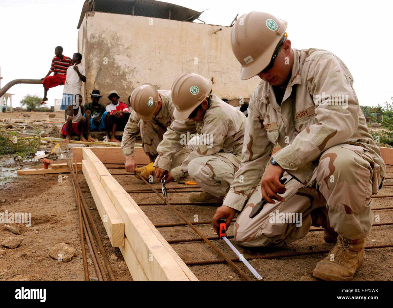 100428-N-8936G-042 NAGHAD, Djibouti (April 28, 2010) Builder Constructionman Joseph Scott, right, from Rock Spring, Ga., Builder Constructionman Selina Rodriguez, from Harlingen, Texas, and Equipment Operator Constructionman Apprentice Corey Moore, from Sebastian, Fla., measure and secure rebar framework on a water distribution pad under construction in Naghad. All are assigned to Naval Mobile Construction Battalion (NMCB) 7 and are operating out of Camp Lemonnier. (U.S. Navy photo/Released) US Navy 100428-N-8936G-042 Builder Constructionman Joseph Scott, Builder Constructionman Selina Rodrigu Stock Photo